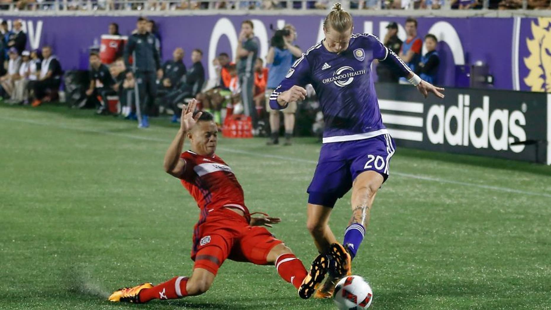 Mar 11, 2016; Orlando, FL, USA; Chicago Fire defender Rodrigo Ramos (13) dives for the ball against Orlando City FC midfielder Brek Shea (20) during the second half of a soccer match at Orlando Citrus Bowl Stadium. The Orlando City FC and the Chicago Fire tied at 1-1. Mandatory Credit: Reinhold Matay-USA TODAY Sports
