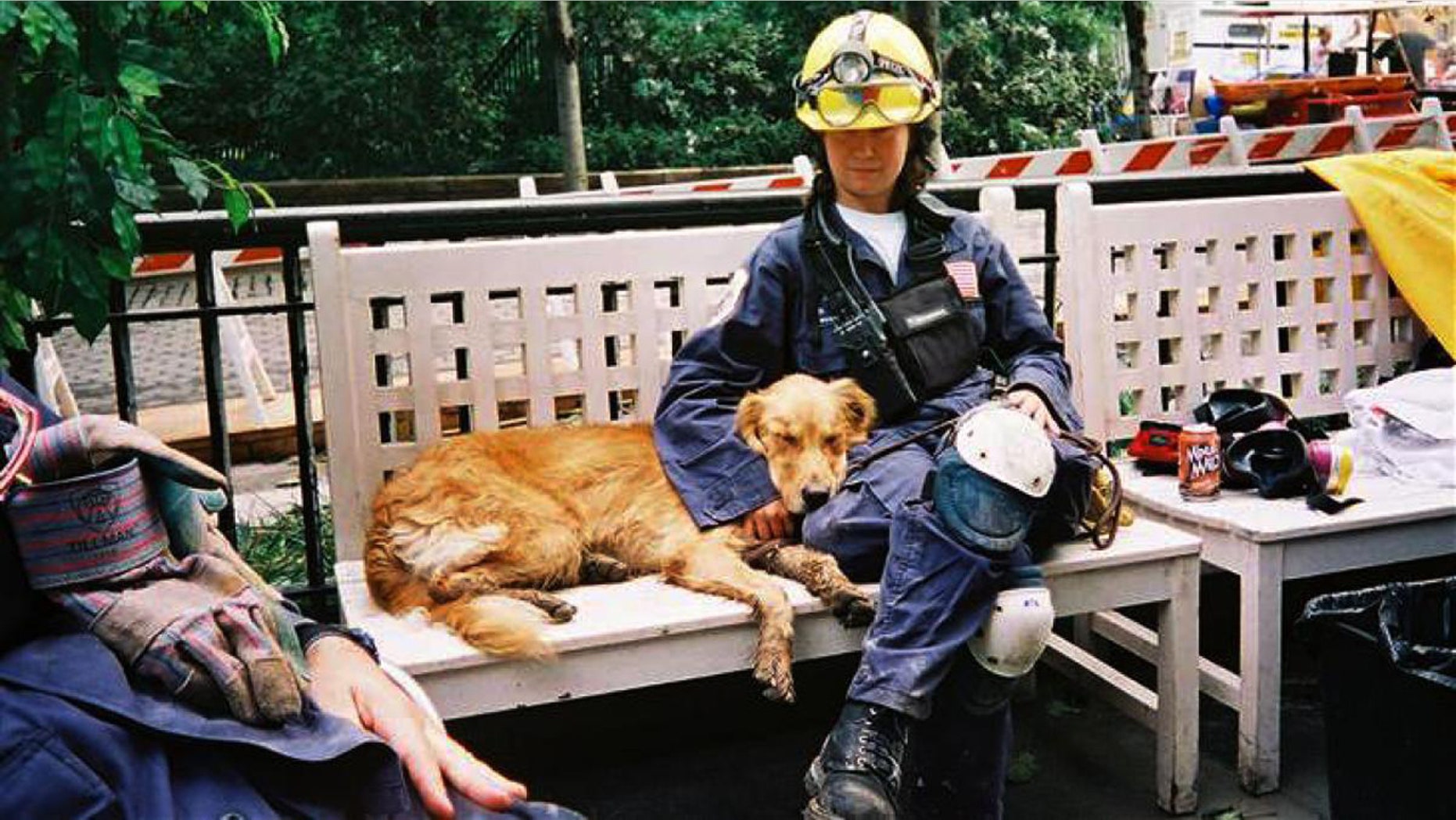 In this undated photo, search dog Bretagne rests alongside handler Denise Corliss while searching Ground Zero after the 9/11 attacks