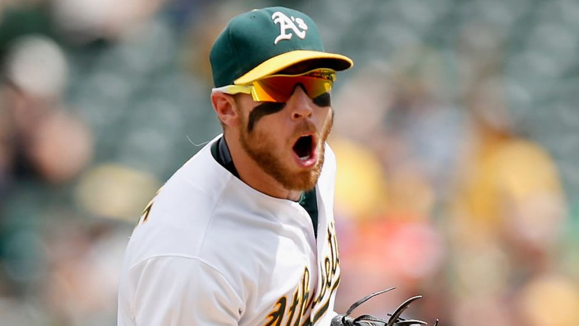 OAKLAND, CA - JULY 01: Brett Lawrie #15 of the Oakland Athletics reacts after he fielded the ball with his bare hand and threw out Ben Paulsen #10 of the Colorado Rockies in the sixth inning at O.co Coliseum on July 1, 2015 in Oakland, California. (Photo by Ezra Shaw/Getty Images)