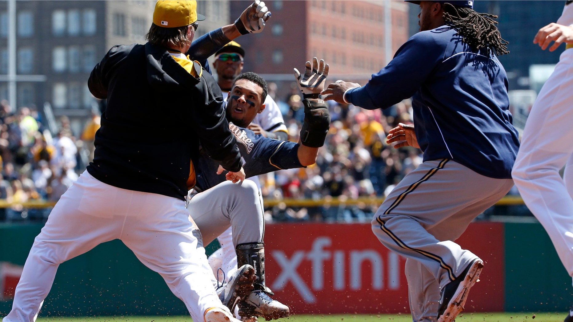 Pittsburgh Pirates' Travis Snider, left, takes down Milwaukee Brewers' Carlos Gomez as Brewers' Rickie Weeks, right, joins a skirmish between the two teams during the third inning of a baseball game in Pittsburgh, Sunday, April 20, 2014. Gomez and Snider were ejected from the game. (AP Photo/Gene J. Puskar)