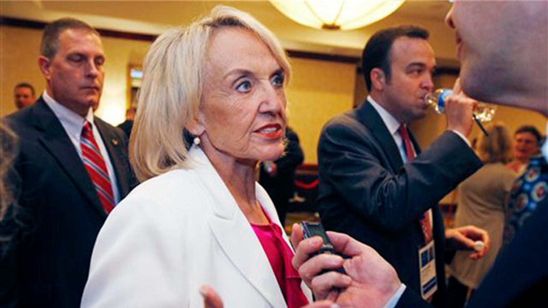 Arizona Gov. Jan Brewer speaks with a reporter during the annual meeting of the National Governors Association July 11. (AP Photo)