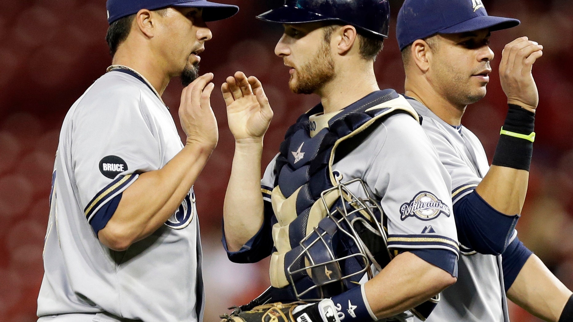 Sept. 24, 2014: In this file photo, Milwaukee Brewers starting pitcher Kyle Lohse, left, is congratulated by catcher Jonathan Lucroy, center, after the Brewers defeated the Cincinnati Reds 5-0 in a baseball game in Cincinnati.