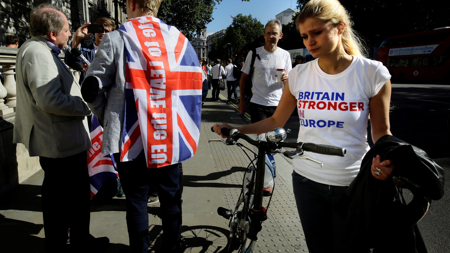 File photo - A vote remain supporter walks past a vote leave supporter outside Downing Street in London, Britain June 24, 2016 after Britain voted to leave the European Union. (REUTERS/Kevin Coombs)