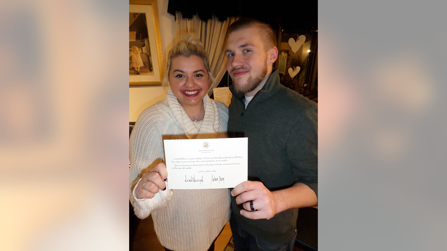 Brianna and Timothy Dargert pose with their letter from the president and first lady.