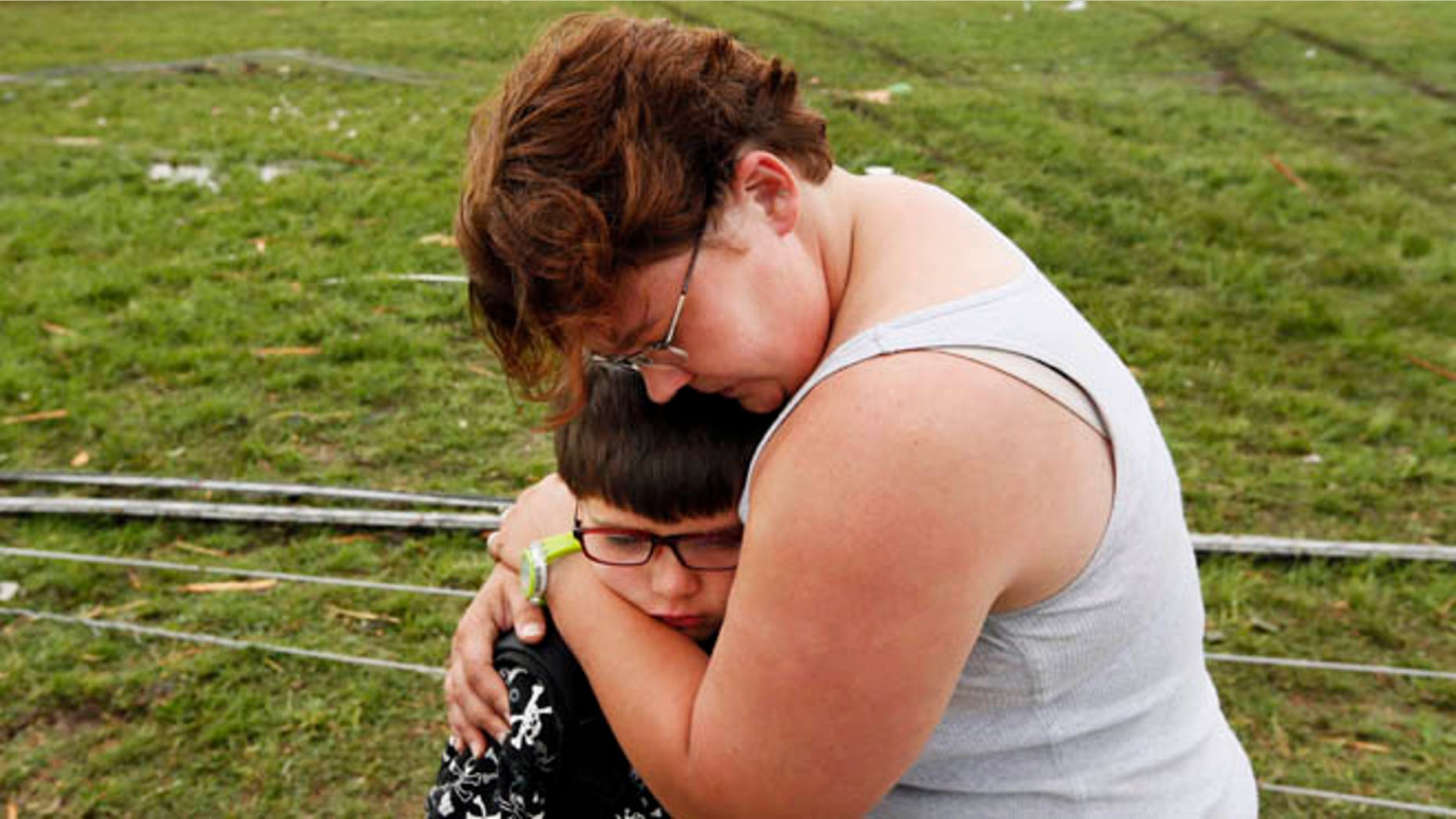 May 20, 2013: Rebekah Stuck hugs her son, Aiden Stuck, 7, after she found him in front of the destroyed Briarwood Elementary after a tornado struck south Oklahoma City and Moore, Okla. Aiden Stuck was inside the school when it was hit.
