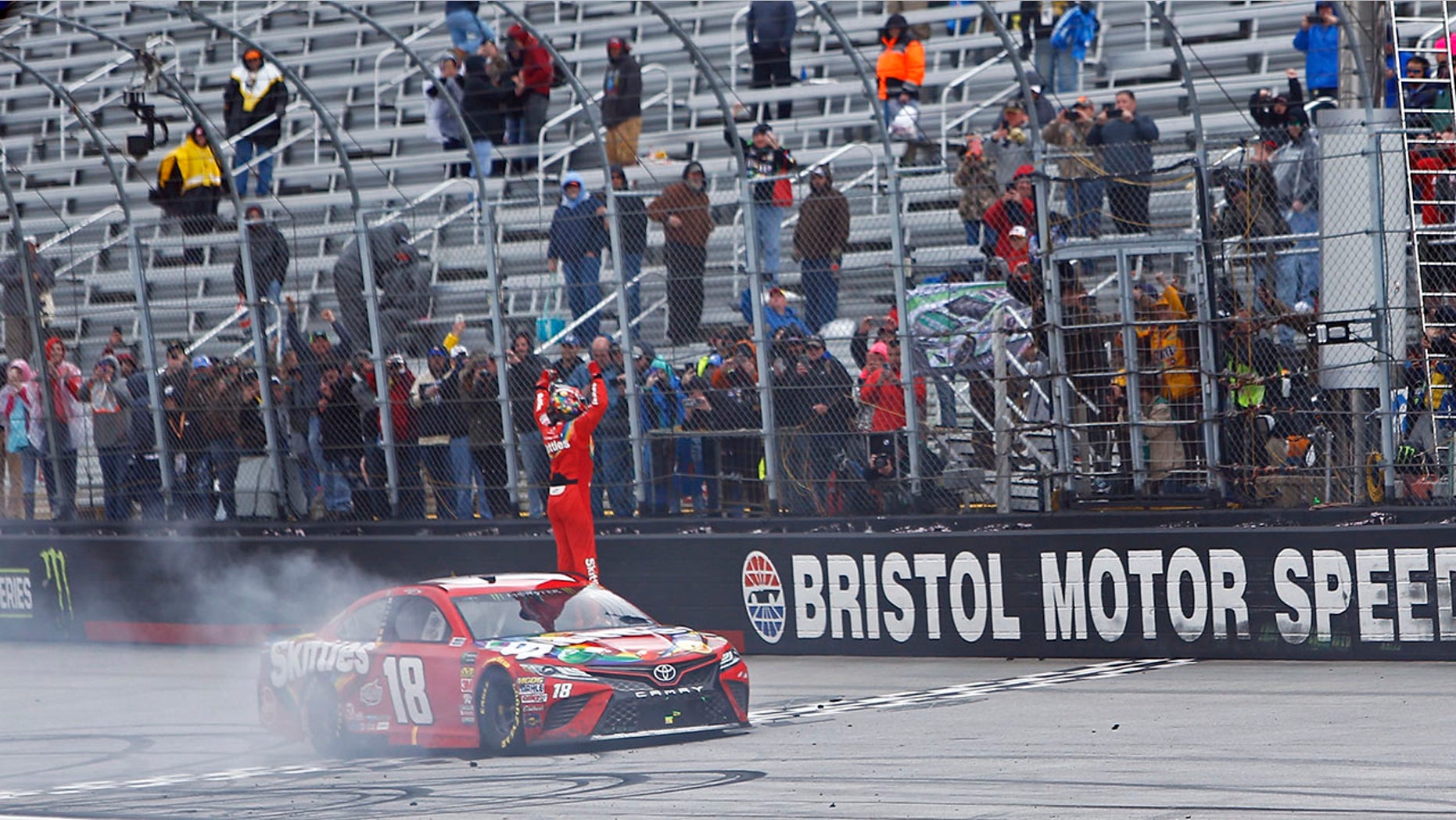 Kyle Busch celebrates after winning during a NASCAR Cup Series auto race, Monday, April 16, 2018 in Bristol, Tenn. (AP Photo/Wade Payne)