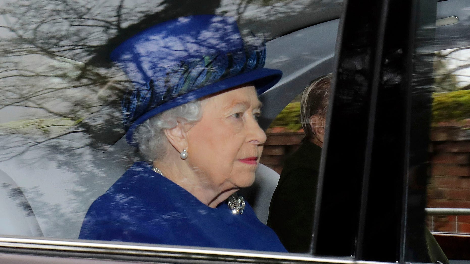 Britain's Queen Elizabeth II in a car with Prince Philip, arrives to attend the morning church service at St Mary Magdalene Church in Sandringham, England, Sunday Jan. 8, 2017. The 90-year-old British monarch was applauded by well-wishers as she arrived by car at St. Mary Magdalene Church in eastern England. It was her first public appearance in several weeks. (Chris Radburn/PA via AP)