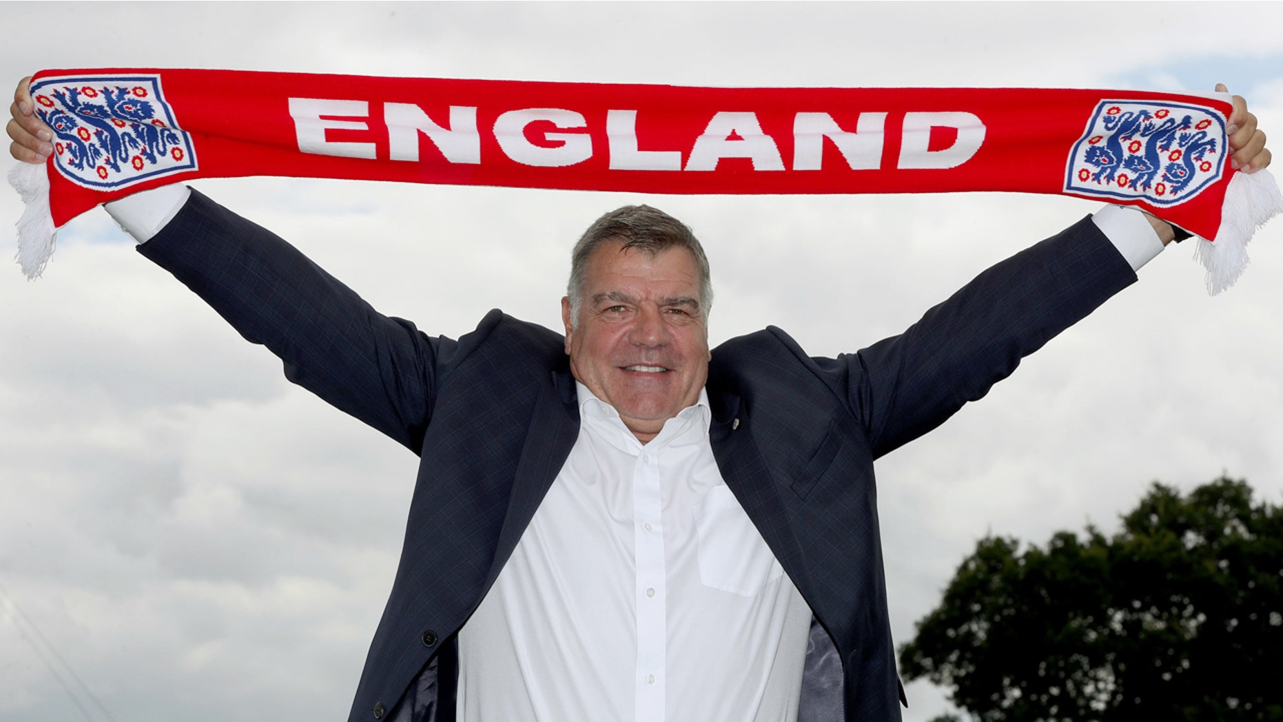 July 25, 2016: Newly appointed England manager Sam Allardyce displays an England scarf, in Burton-on-Trent, England.