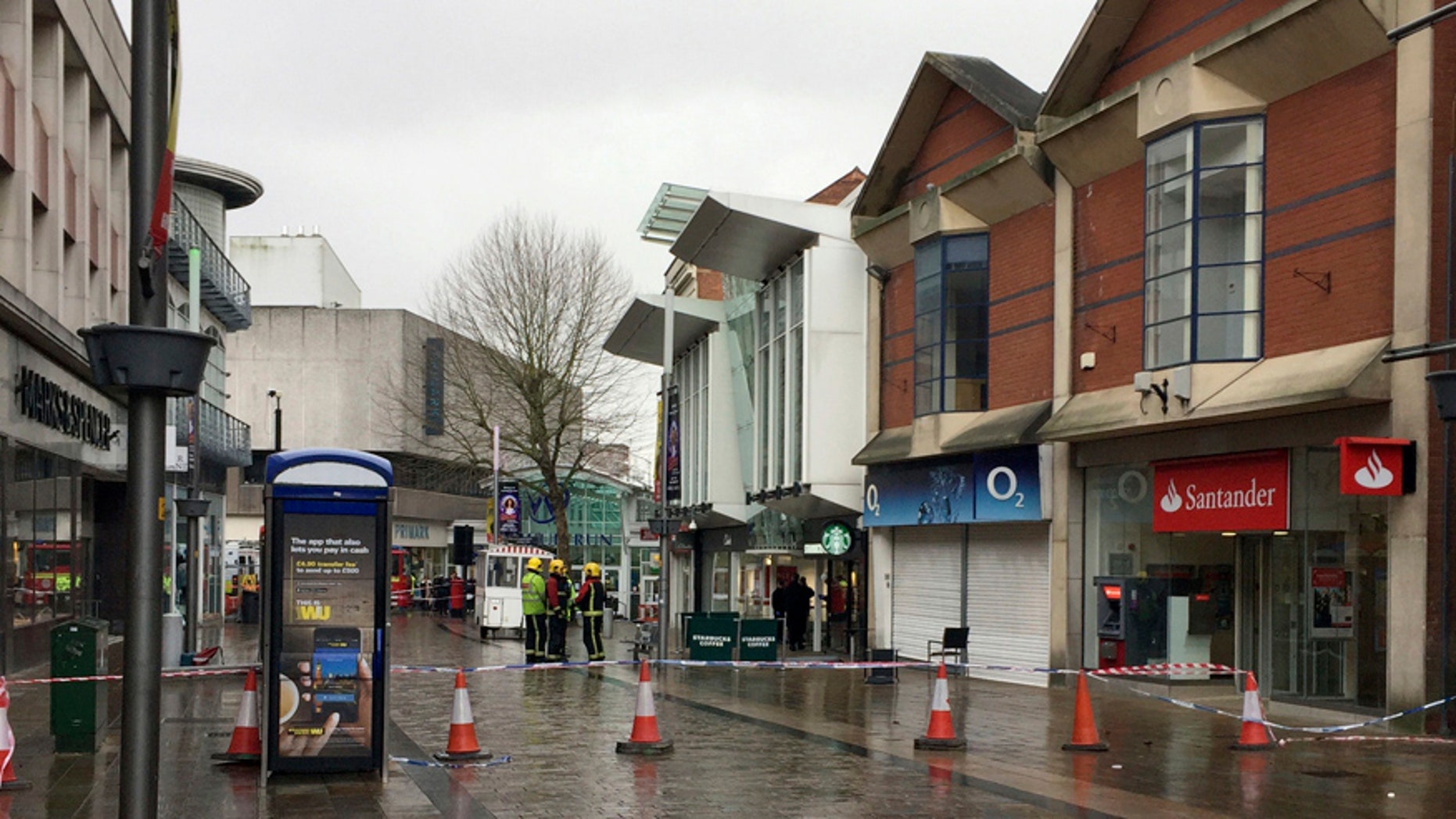 The scene in Wolverhampton city center after a woman died when she was hit by a piece of roof the "size of a coffee table" during strong winds, Wolverhampton, England, Thursday, Feb. 23, 2017. Flights have been cancelled and commuters were warned they faced delays after Storm Doris reached nearly 90mph. (Matthew Cooper/PA via AP)