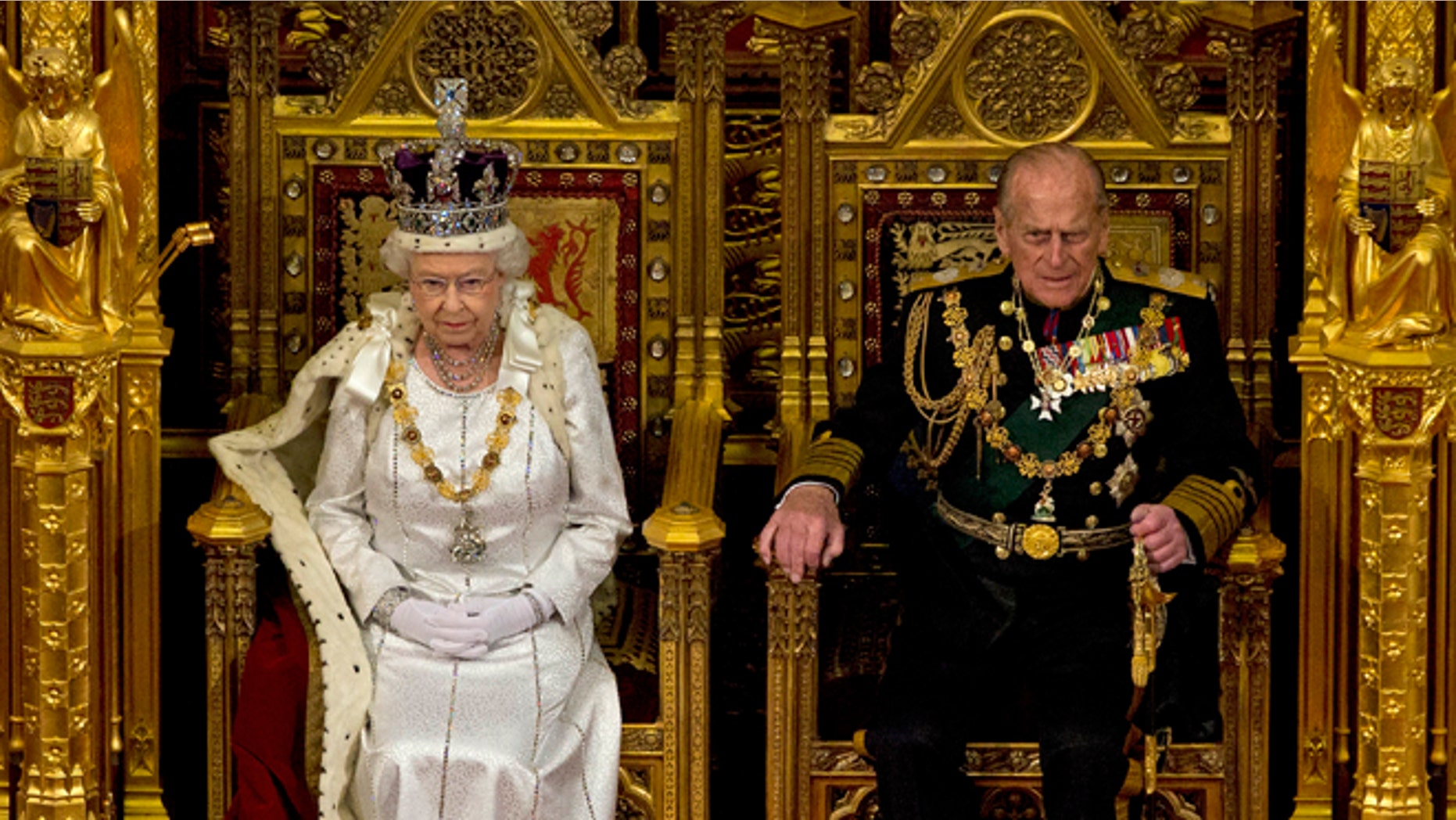 May 9, 2012: Britain's Queen Elizabeth II sits next to Prince Philip in the House of Lords as she waits to read the Queen's Speech to lawmakers in London.