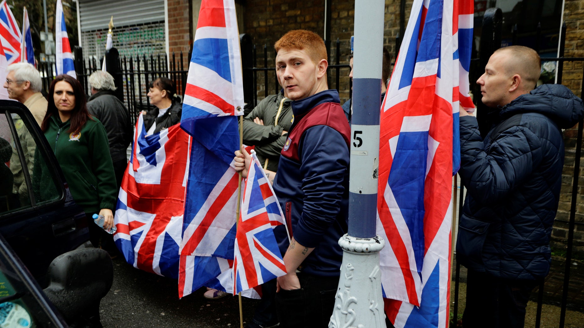 File photo - People hold the Union Flag whilst attending a Britain First rally as deputy leader Jayda Fransen (L) looks on, in Rochester, Britain November 15, 2014. (REUTERS/Kevin Coombs)