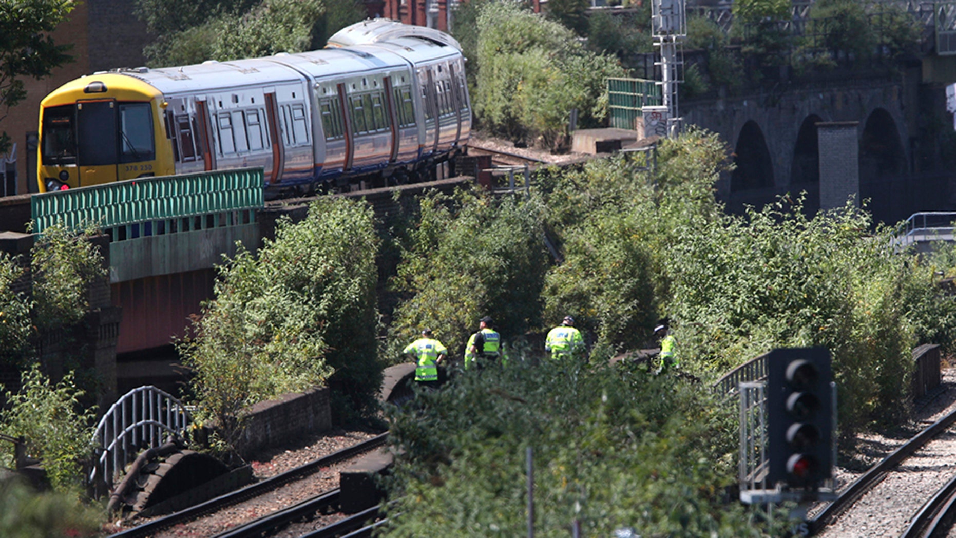 June 18, 2018: Police officers inspect a railway track near Loughborough Junction railway station, in south London.
