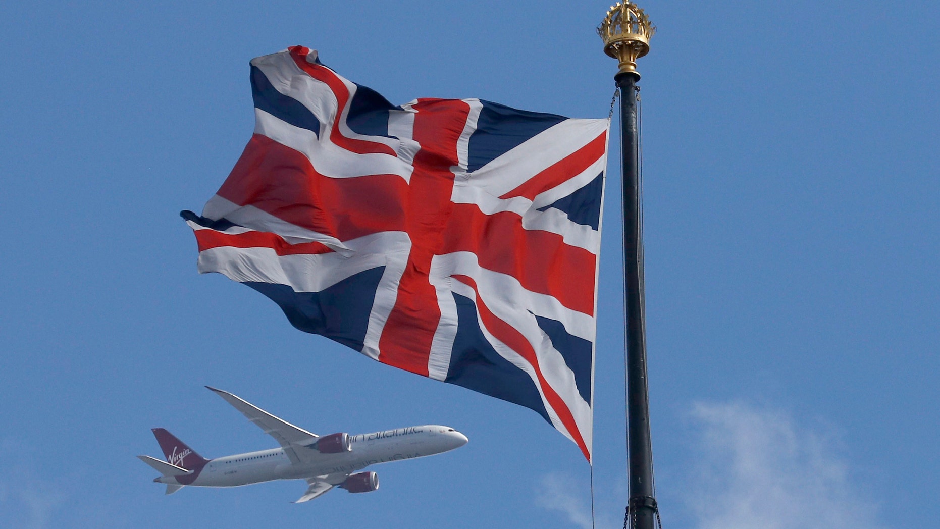 File photo - A Virgin Atlantic passenger jet flies past the Union Flag above the Houses of Parliament in Westminster, in central London, Britain June 24, 2016. (REUTERS/Phil Noble)