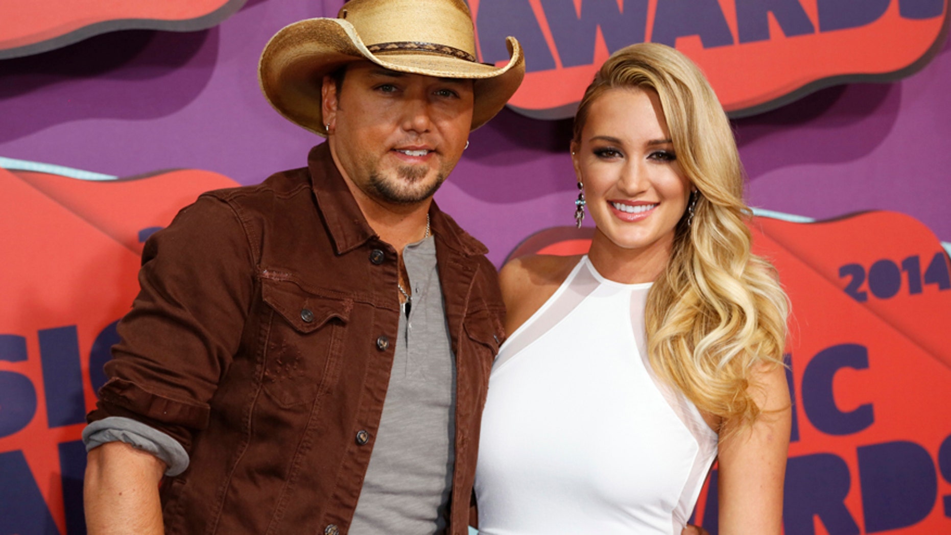 Musician Jason Aldean and guest arrive at the 2014 CMT Music Awards in Nashville, Tennessee June 4, 2014. REUTERS/Eric Henderson (UNITED STATES - Tags: ENTERTAINMENT) - RTR3S97P