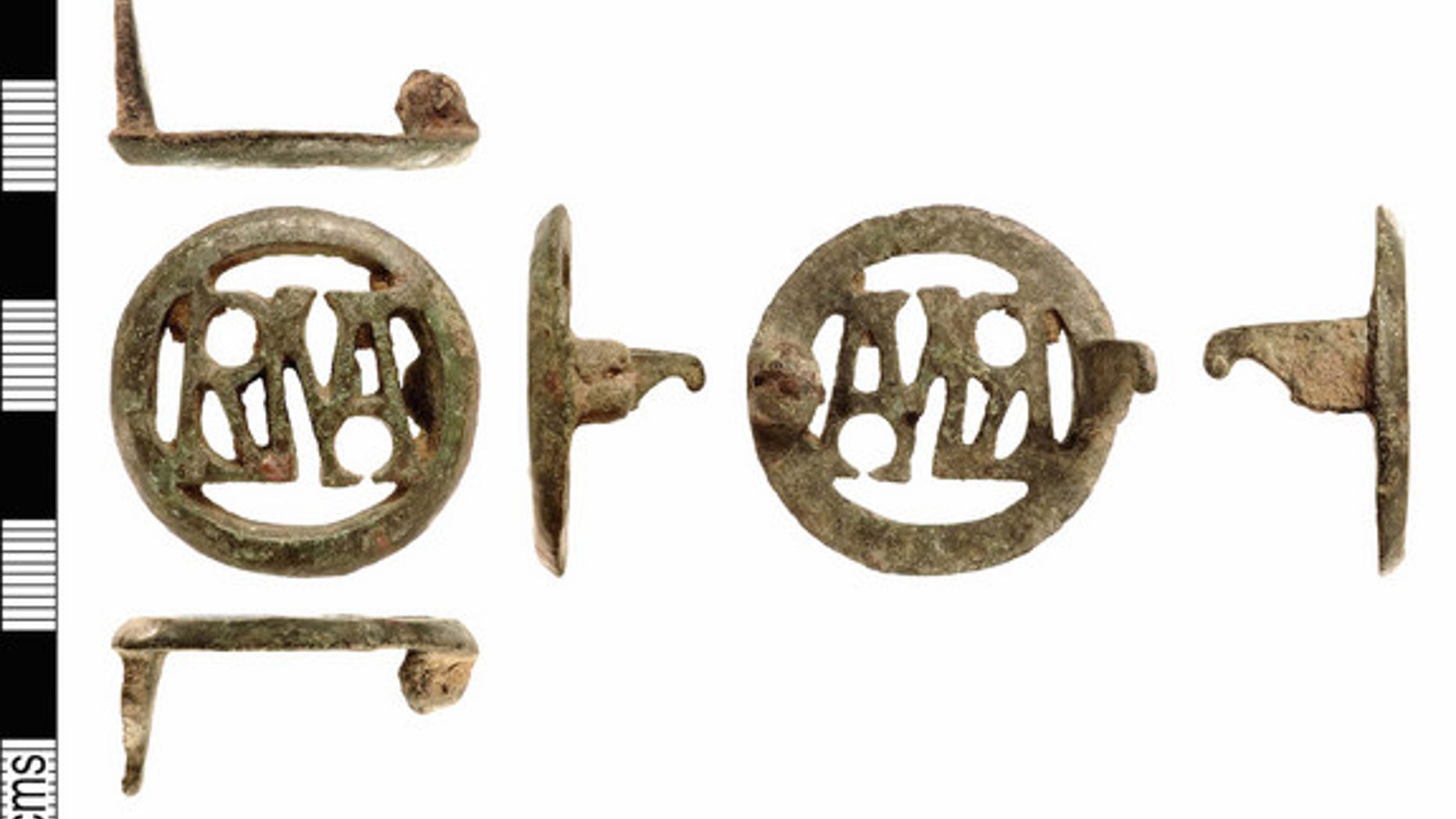 This copper brooch contains the letters "RMA," which when read from left to right forms the monogram for "Roma" the city of Rome and its god. Read from right to left it forms the monogram for "Amor" the Latin name for Cupid, the god of Love. Th