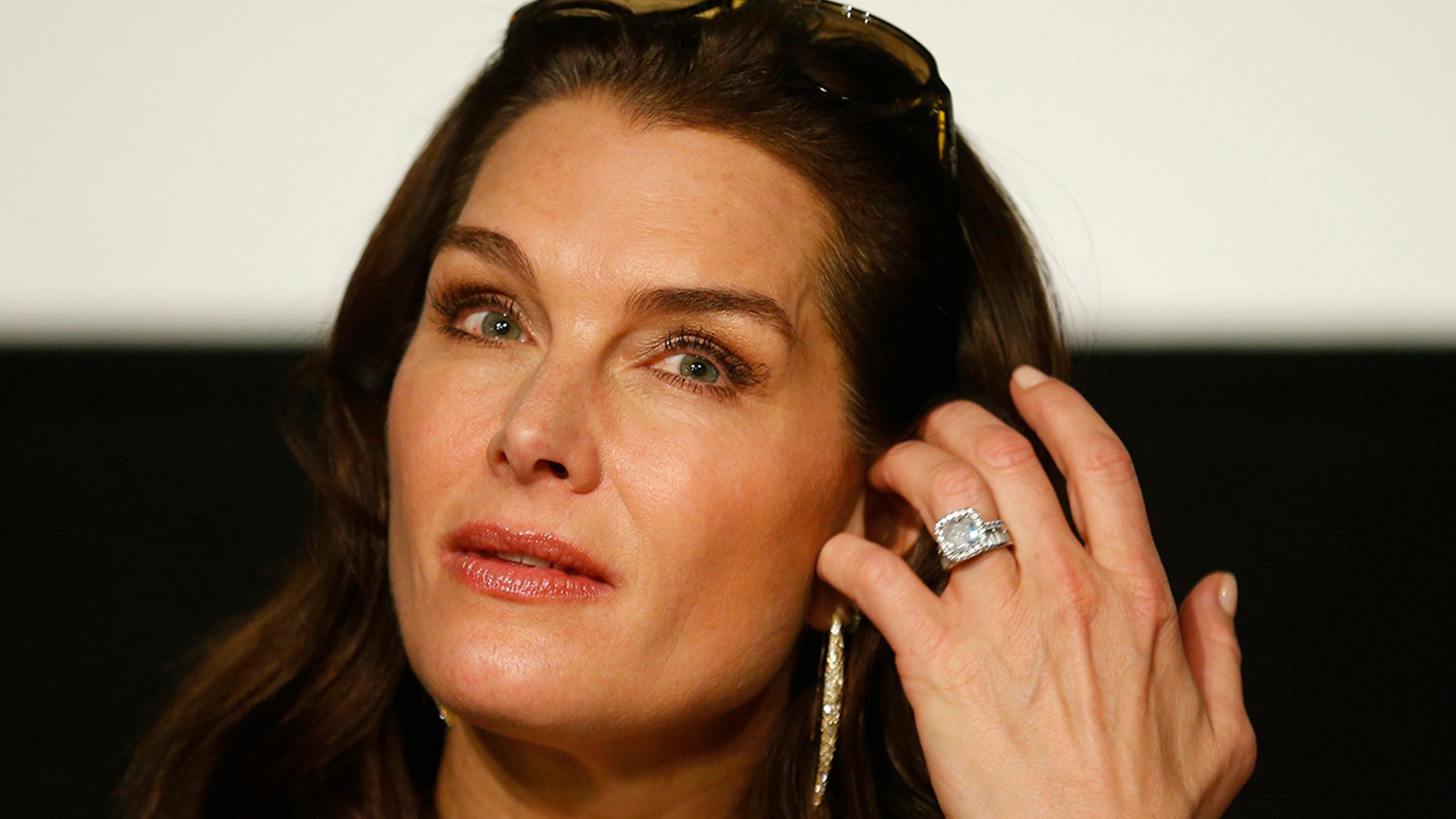 Actress Brooke Shields listens during a news conference the day before attending the traditional Opera Ball in Vienna, Austria, February 3, 2016. REUTERS/Heinz-Peter Bader - LR1EC2311JIA6