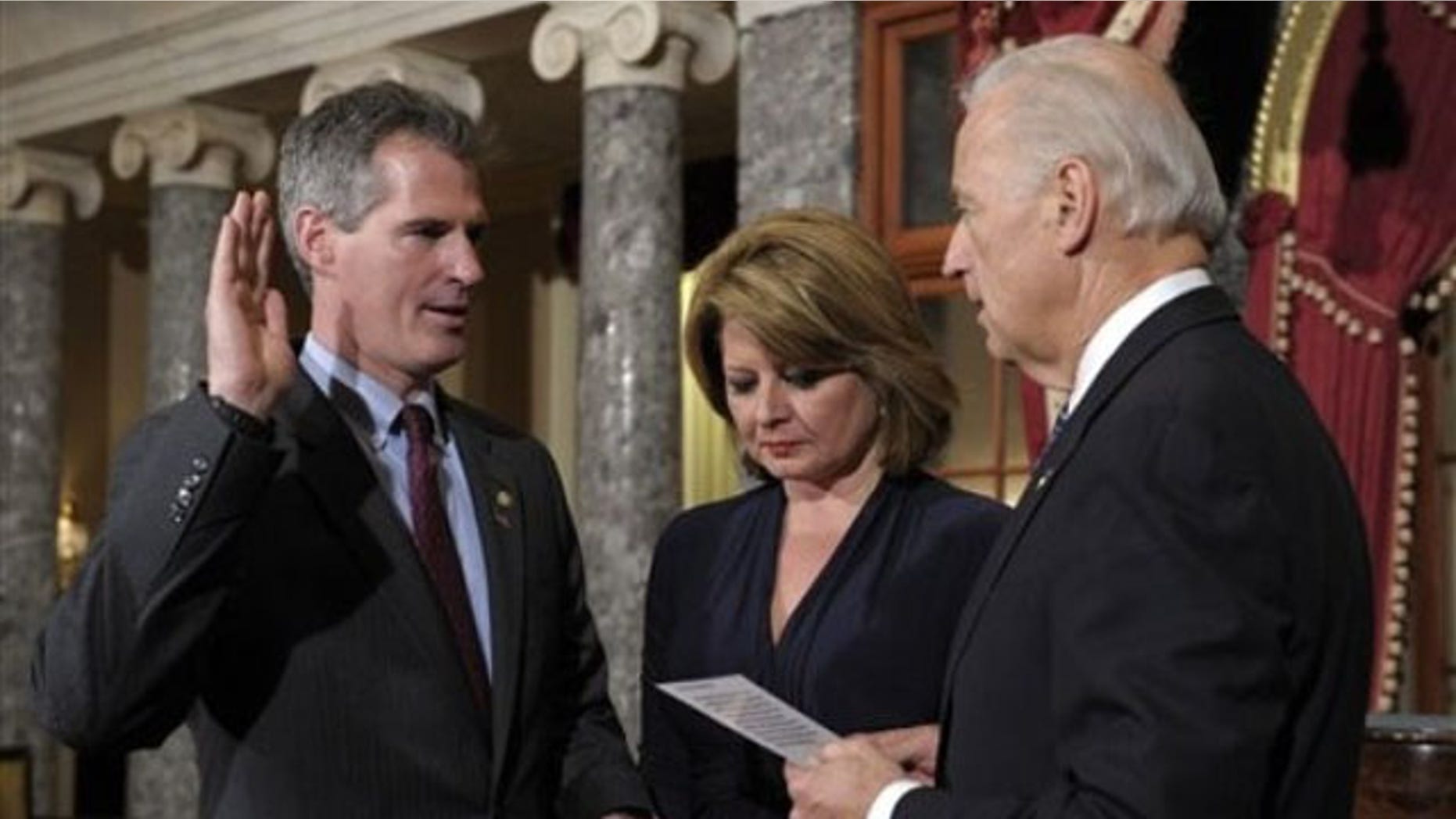 In this Feb. 4 photo, Vice President Biden, right, reenacts the swearing in of Sen. Scott Brown, left, as Brown's wife Gail Huff holds the family bibles in the Old Senate Chamber. (AP Photo)