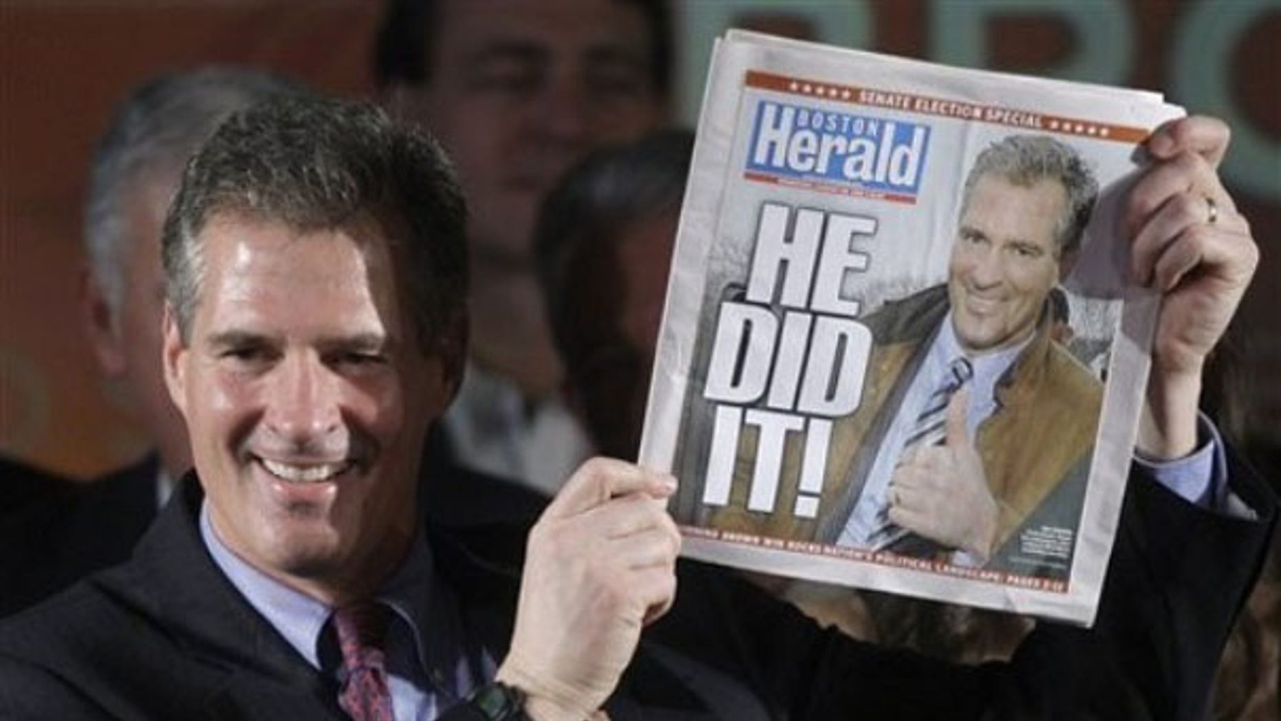 Scott Brown holds up a copy of the Boston Herald as he celebrates his election victory in Boston Jan. 19. (AP Photo)