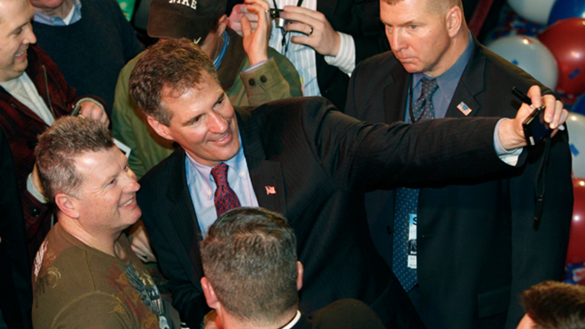 Tuesday: U.S. Senator-Elect Scott Brown takes a photo of himself and a supporter at his victory party after winning the special election to fill the seat left vacant by the death of Massachusetts Sen. Edward Kennedy. (AP Photo)