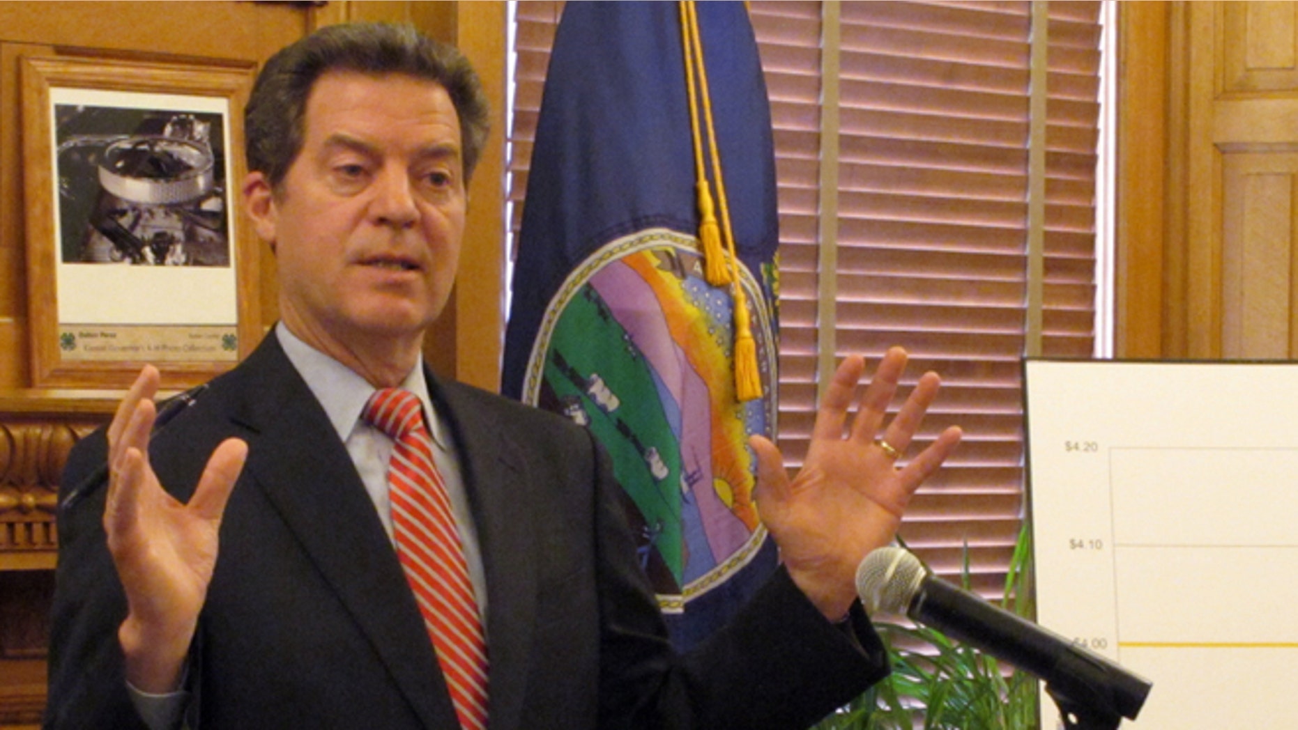 April 2, 2015: Kansas Gov. Sam Brownback answers questions from reporters about pension issues during a news conference at the Statehouse in Topeka, Kan.