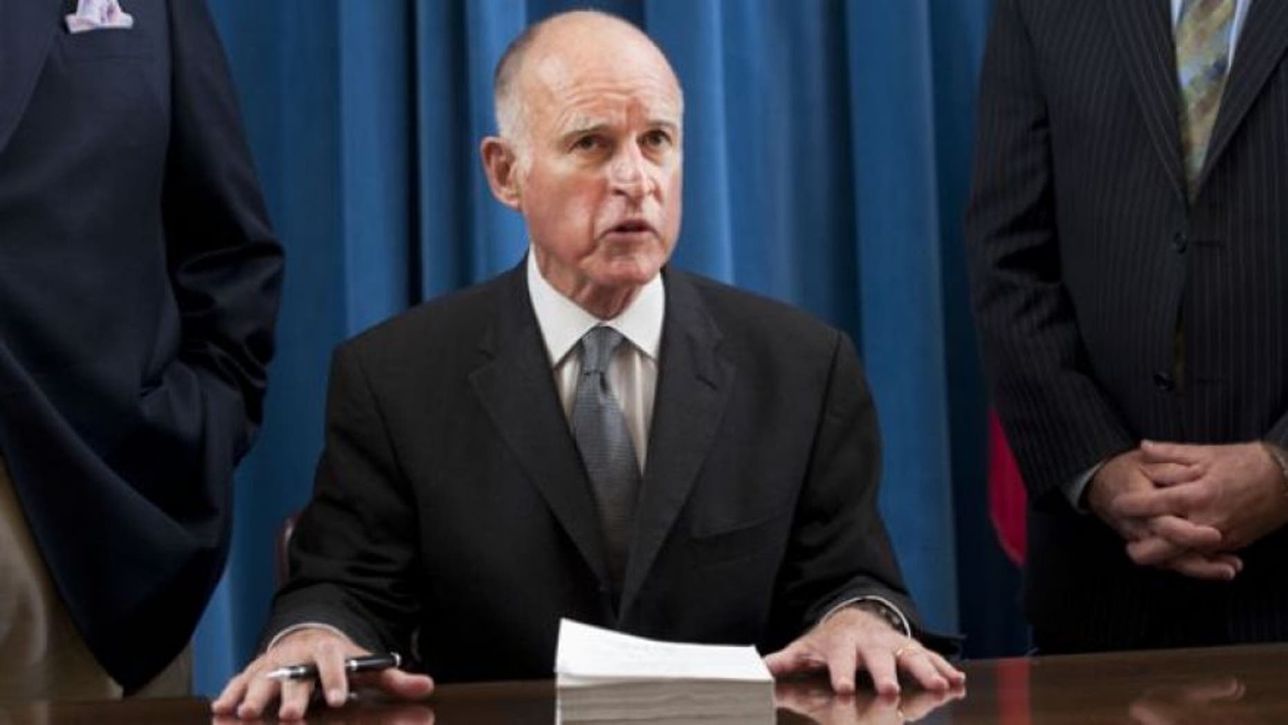 FILE: June 30, 2011: California Gov. Jerry Brown signs the state budget.