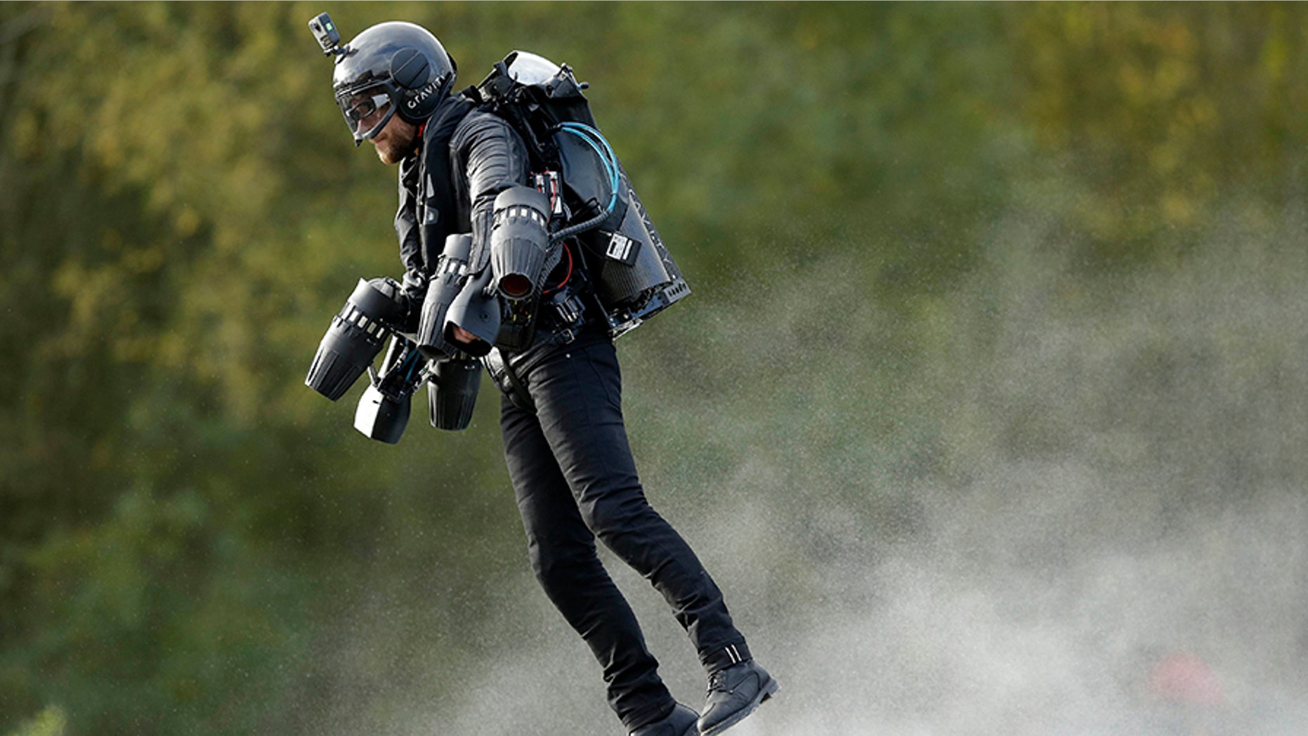 Richard Browning sets the Guinness World Record for 'the fastest speed in a body-controlled jet engine power suit', at Lagoona Park in Reading, England, Thursday, Nov. 9, 2017. A British inventor billed as a real-life version of the superhero Iron Man has hit the fastest speed in a body-controlled jet engine power suit at 32 mph (51 kph) to set a new Guinness world record. The record keeper announced Tuesday's feat on Thursday as part of its annual Guinness World Records day. (Tim Ireland/PA via AP)