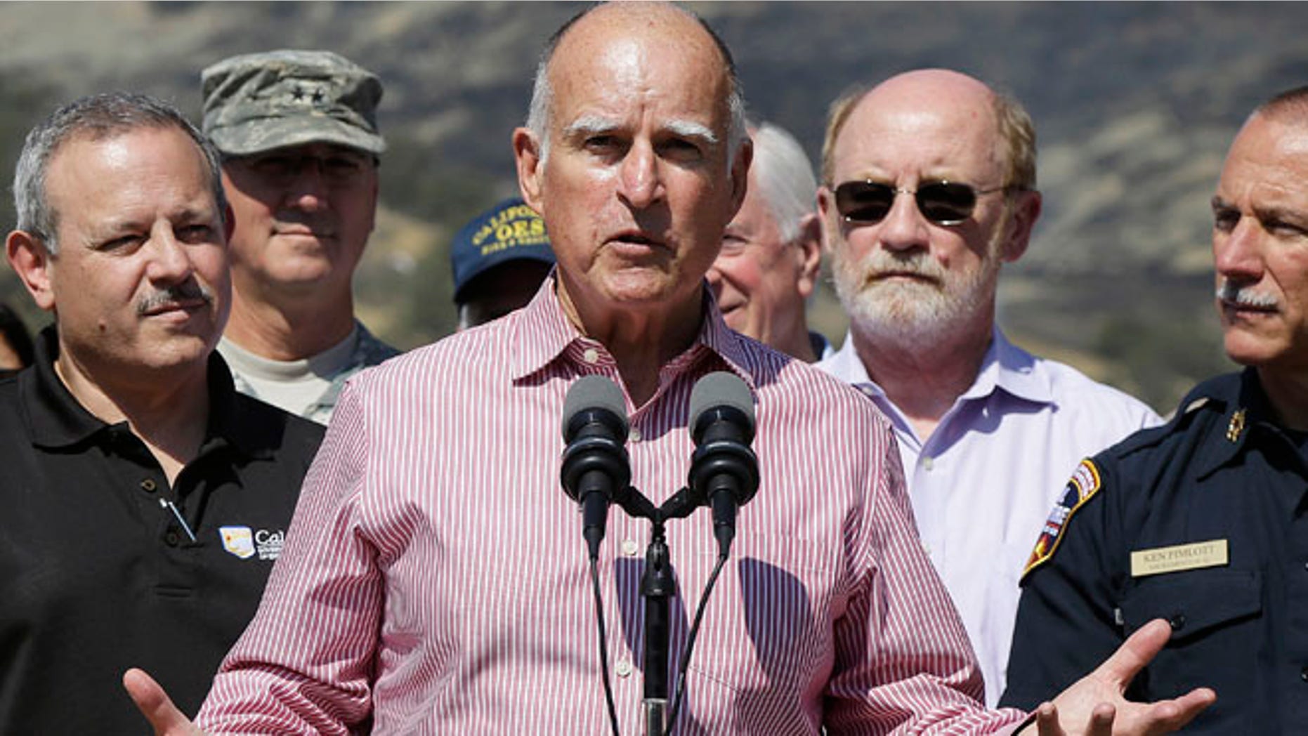 Aug 6, 2015: Gov. Jerry Brown, center, speaks next to Mark Ghilarducci, director of the California Governors Office of Emergency Services, left, and Cal Fire Chief Ken Pimlott, right, at a news conference at Cowboy Camp Trailhead near Clearlake, Calif.