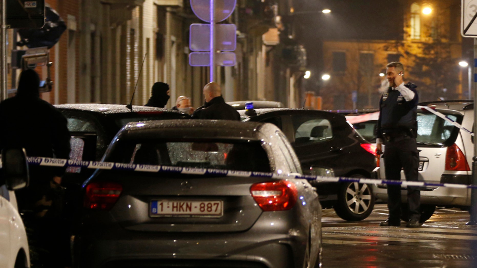 March 25, 2016: Police guard a checkpoint and man positions during a police raid in the suburb of Schaerbeek in Brussels.