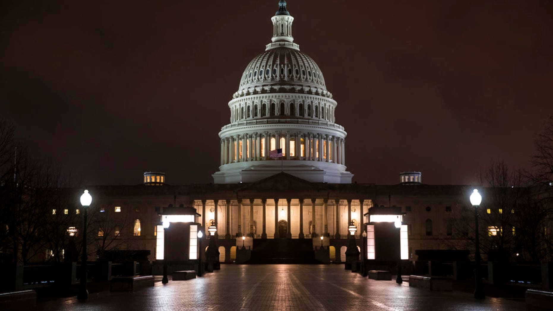 The Capitol is seen before dawn Wednesday after a night of negotiating on the government spending bill, in Washington, March 21, 2018. Talks over a $1.3 trillion omnibus bill are almost complete as the White House and Capitol Hill Democrats ironed out deals on a first round of funding for President Donald Trump's U.S.-Mexico border wall. (AP Photo/J. Scott Applewhite)