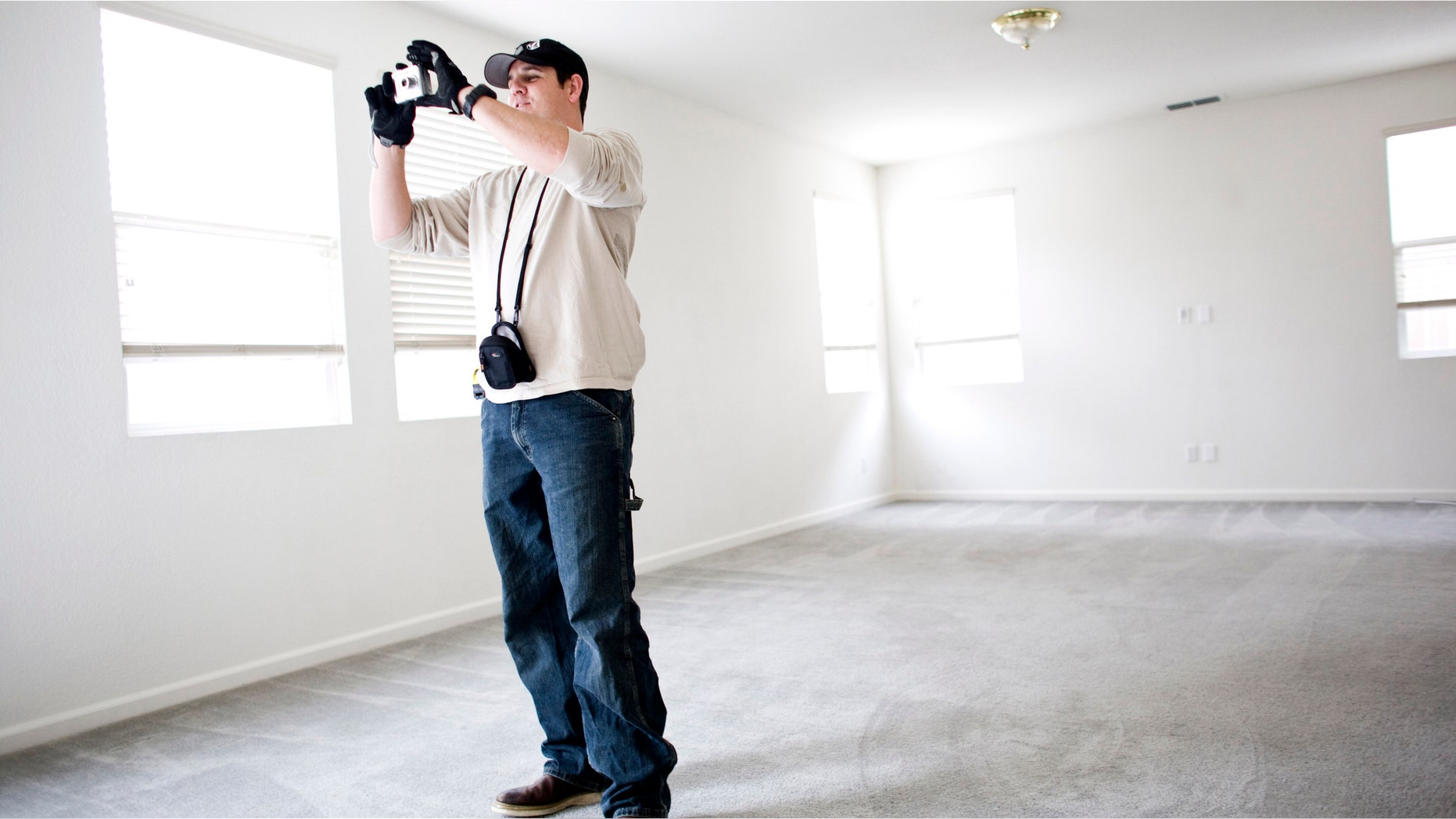 Inspector Manny Navarez inspects a foreclosed home for needed repairs December 2, 2008 in Sacramento, California.