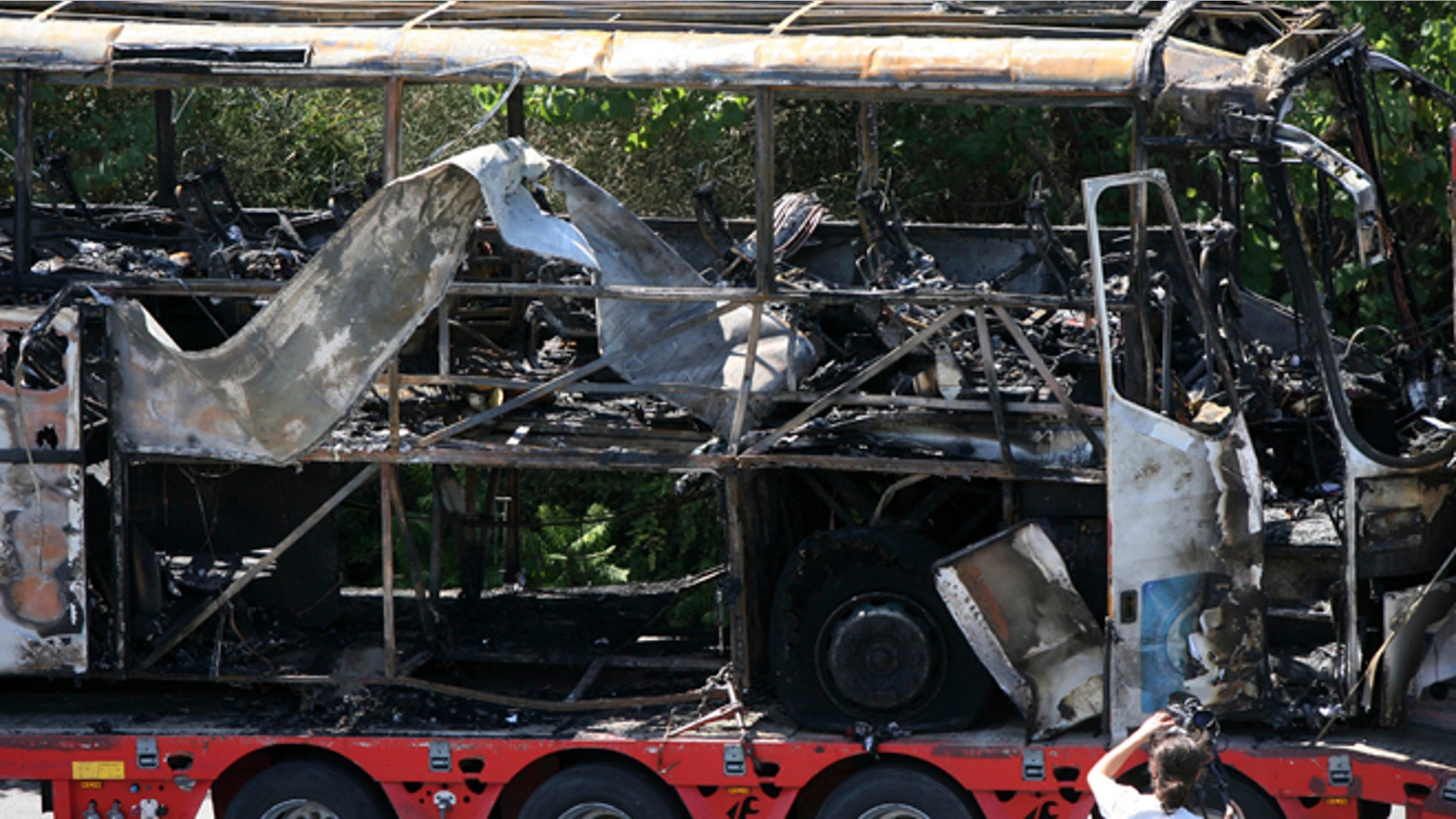 July 19, 2012: In this file photo, a damaged bus is transported out of Burgas airport, Bulgaria, a day after a deadly suicide attack on a bus full of Israeli vacationers.