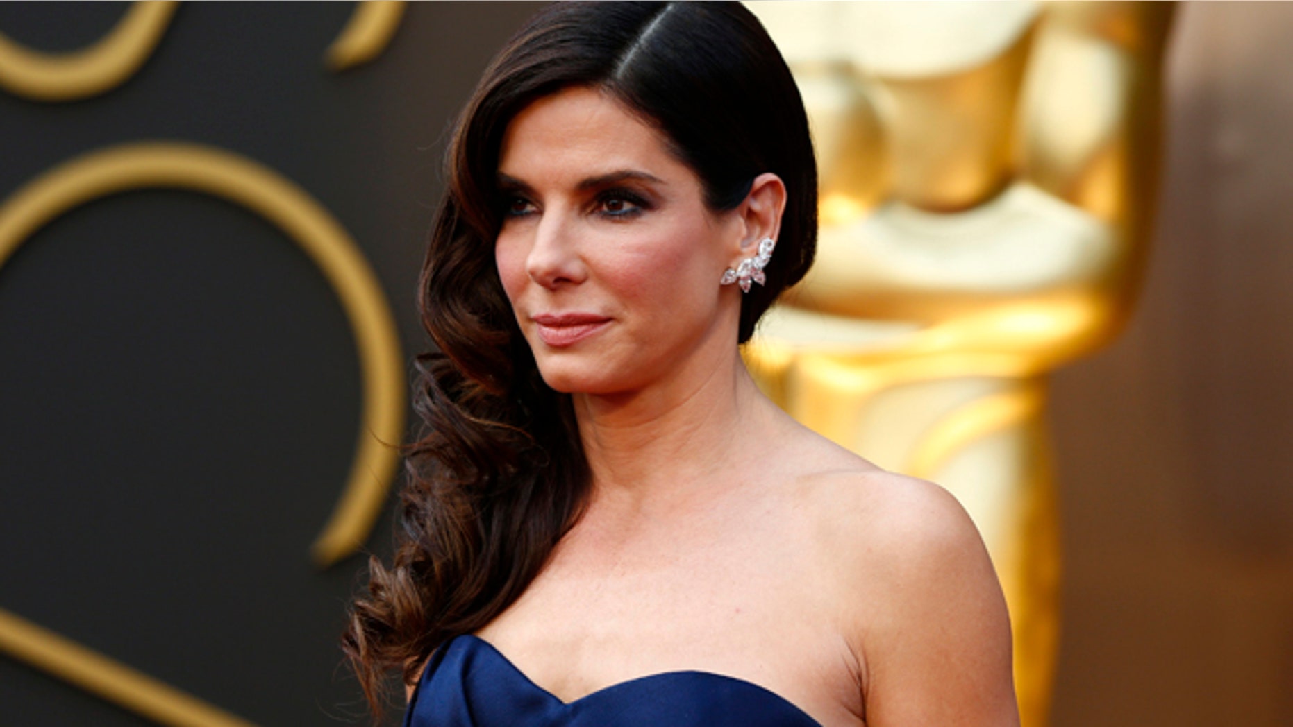Mar 2, 2014: Sandra Bullock, best actress nominee for her role in "Gravity," wearing a navy Alexander McQueen gown with Lorraine Schwartz jewels, arrives at the 86th Academy Awards in Hollywood, California.