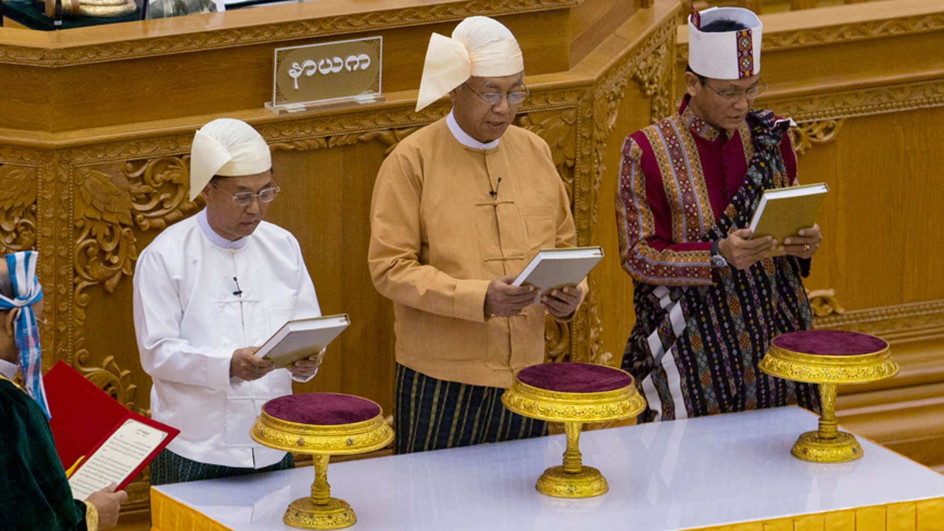 March 30, 2016: Lawmakers from right, Henry Van Hti Yu as seconnd vice president, Htin Kyaw as president and Myint Swe as first-vice president, take oaths during a ceremony in parliament in Naypyitaw, Burma.