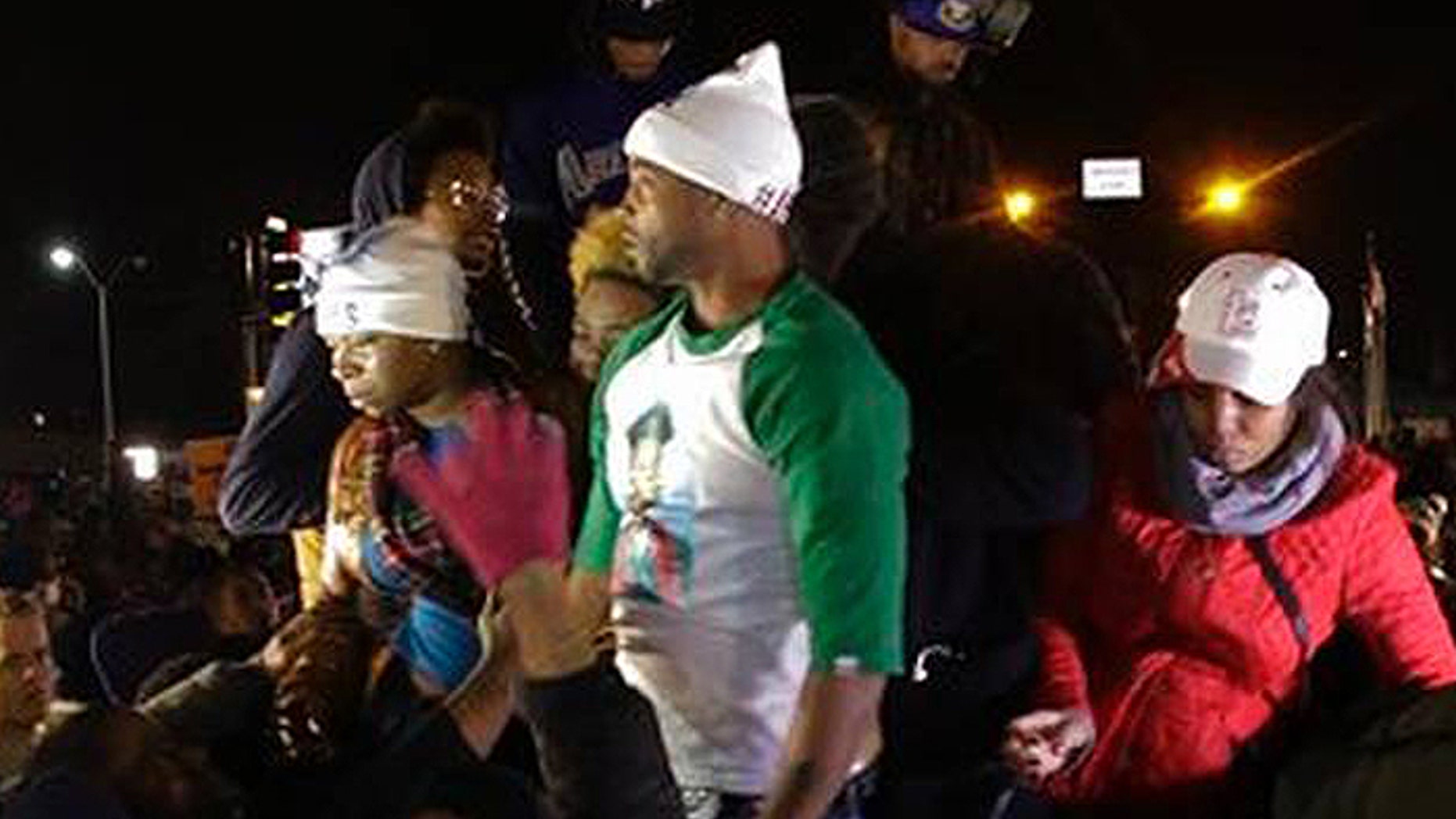 Louis Head, shown here in the green and white shirt, was videotaped shouting "Burn this bitch down!" after a grand jury declined to indict Ferguson Police Officer Darren Wilson in the shooting of Head's stepson, Michael Brown. (AP)