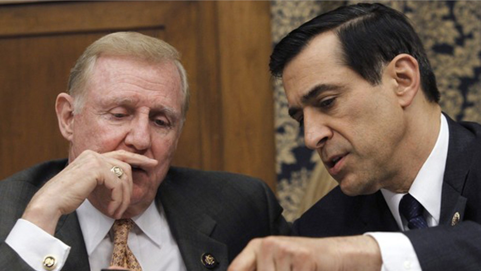 Rep. Dan Burton (R-IN) (L) and Rep. Darrell Issa (R-CA) hold a discussion during a House Committee on Oversight and Government Reform hearing, February 24, 2010. (Reuters)