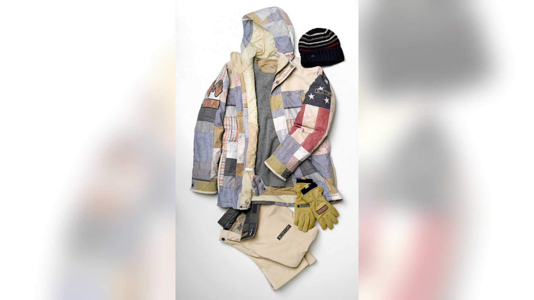 In this undated photo provided by Burton, the U.S. Olympic competition uniform for men snowboarders is shown. The uniforms are built around the competition jacket with squares of stars, stripes and plaids. (AP/Burton)