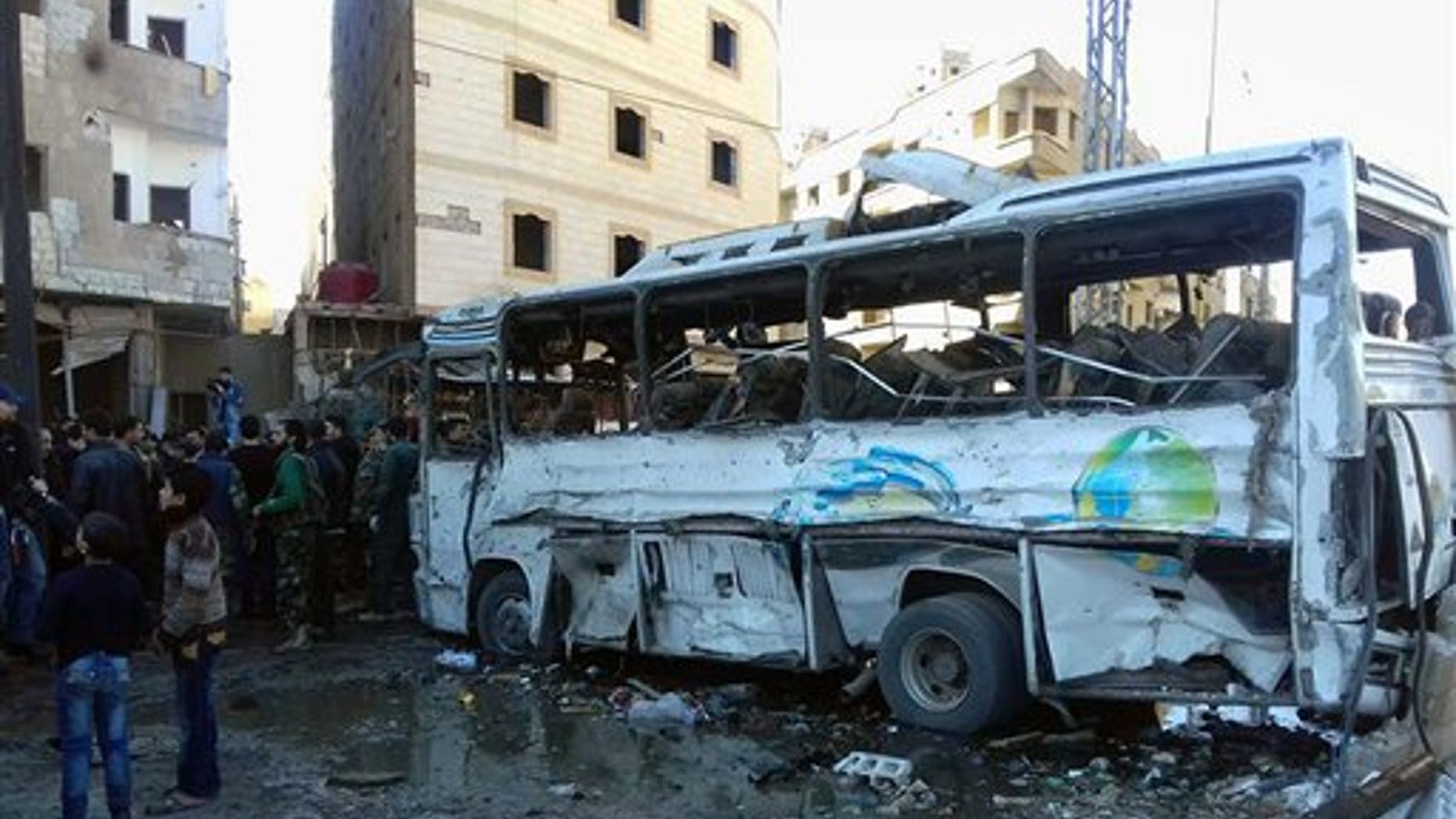 Syrians gather around wreckage following a triple bombing in Sayyda Zeinab by the ISIS terror group that killed 45 people on Jan. 31, 2016. (SANA via AP)