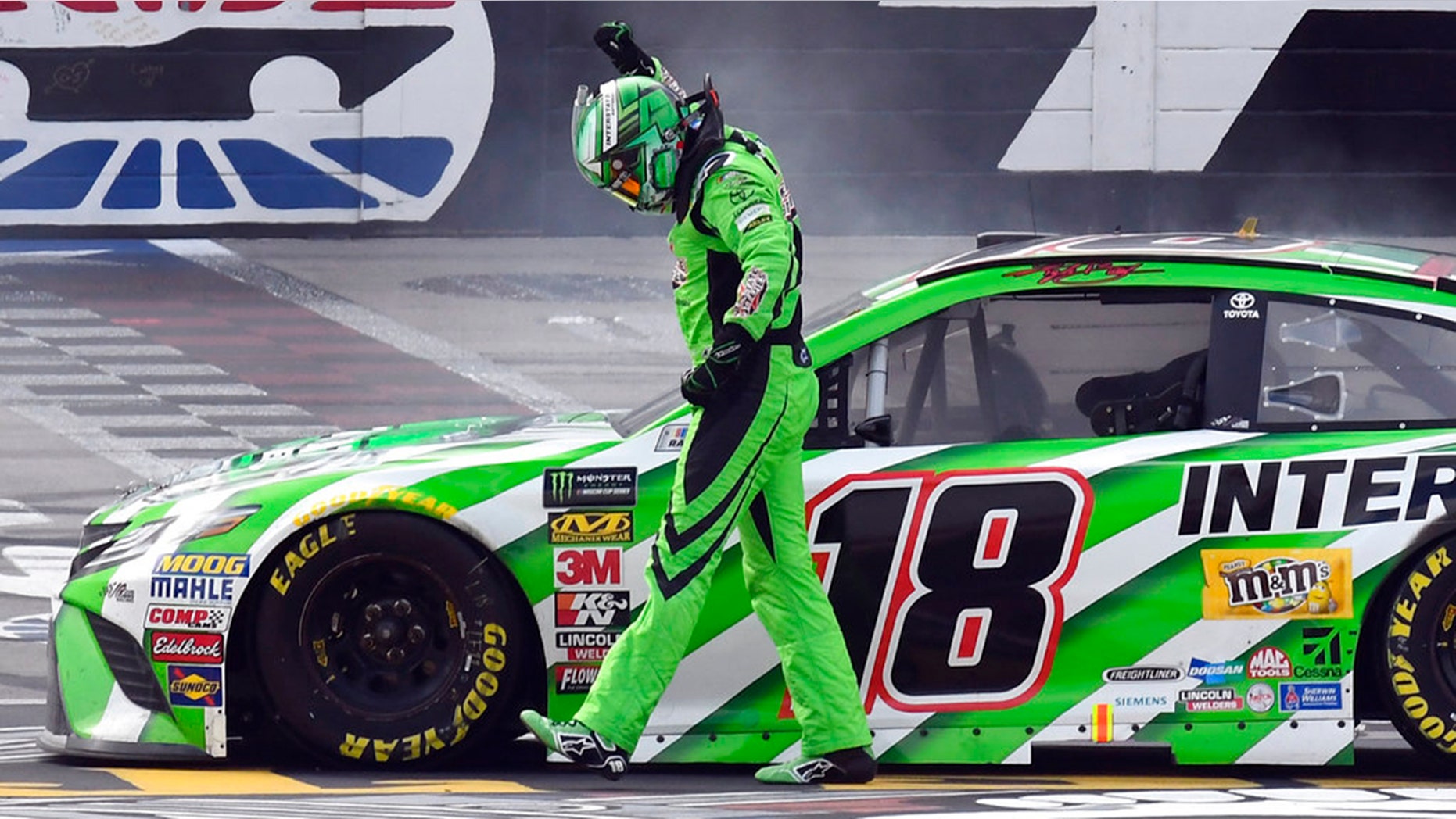 Kyle Busch (18) celebrates after winning a NASCAR Cup Series auto race in Fort Worth, Texas, Sunday, April 8, 2018. (AP Photo/Larry Papke)