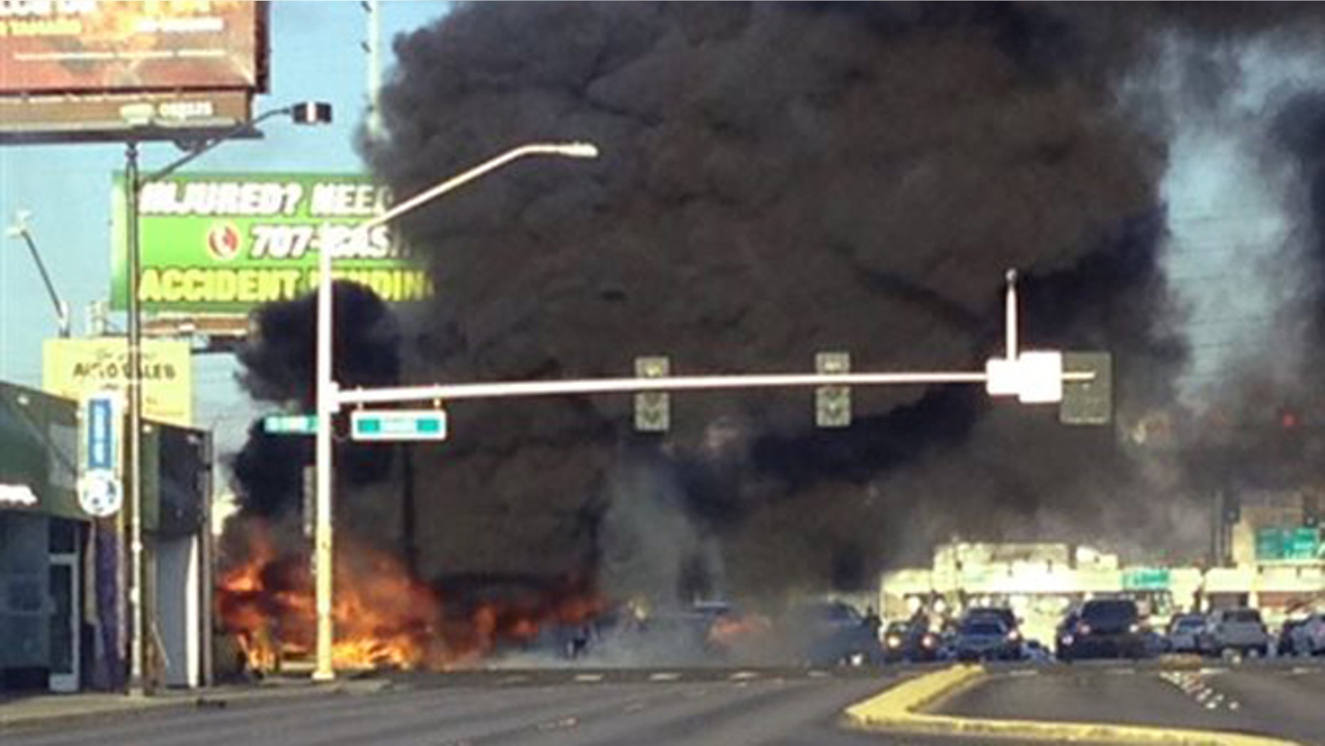 Sept. 5, 2015: Smoke filled the sky after a fire tore through a mini bus following a collision in Las Vegas.