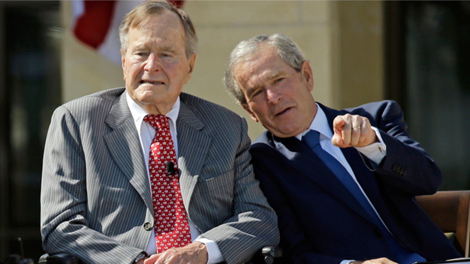 April 25, 2013: Former President George W. Bush talks with his father, former President George H. W. Bush, left, during the dedication of the George W. Bush Presidential Center in Dallas.