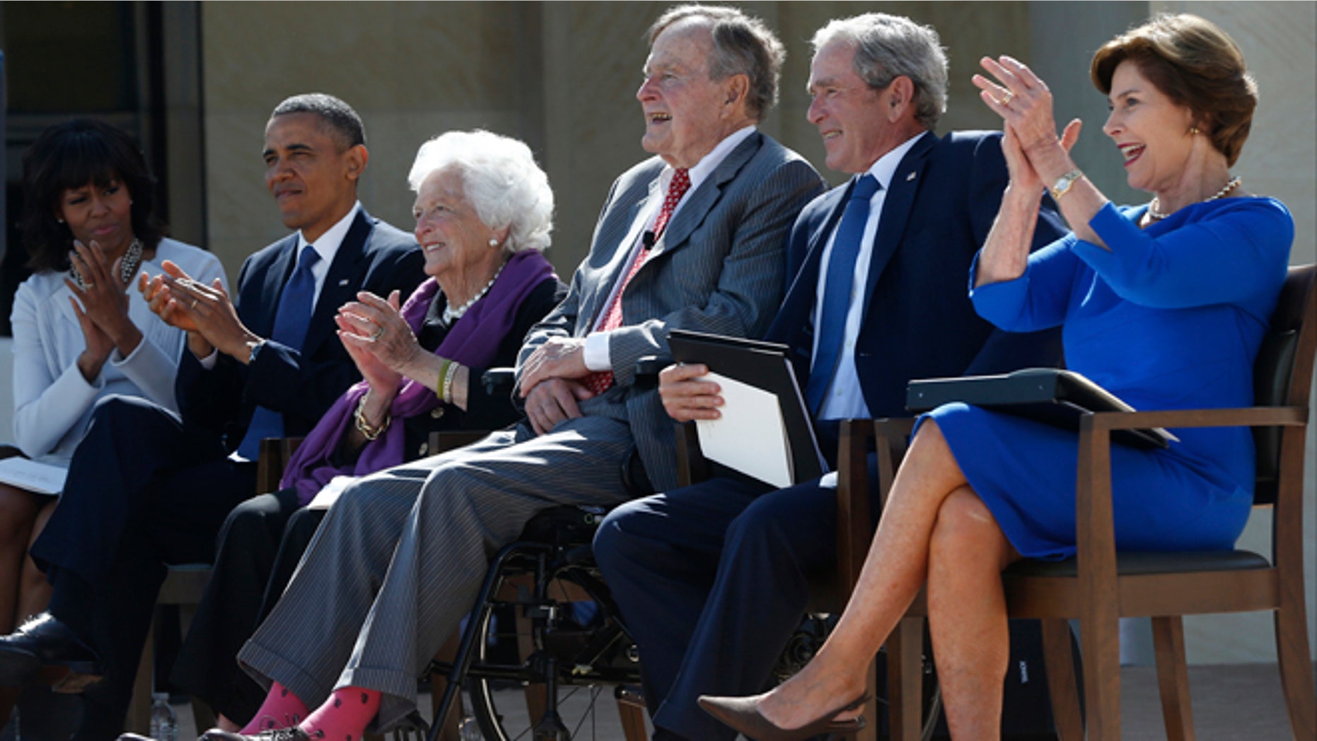 April 25, 2013: From left, President Barack Obama, first lady Michelle Obama, former first lady Barbara Bush, former Presidents George H.W. Bush, George W. Bush, and former first lady Laura Bush take part in the dedication of the George W. Bush presidential library on the campus of Southern Methodist University in Dallas.