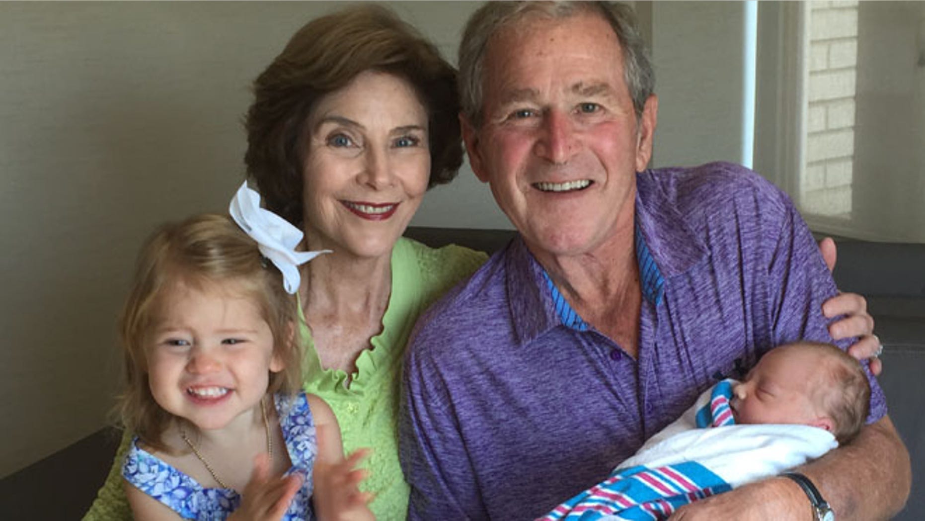 Aug 14, 2015: George W. Bush and his wife Laura hold their new granddaughter, Poppy Louise Hager. (The Bush Family)