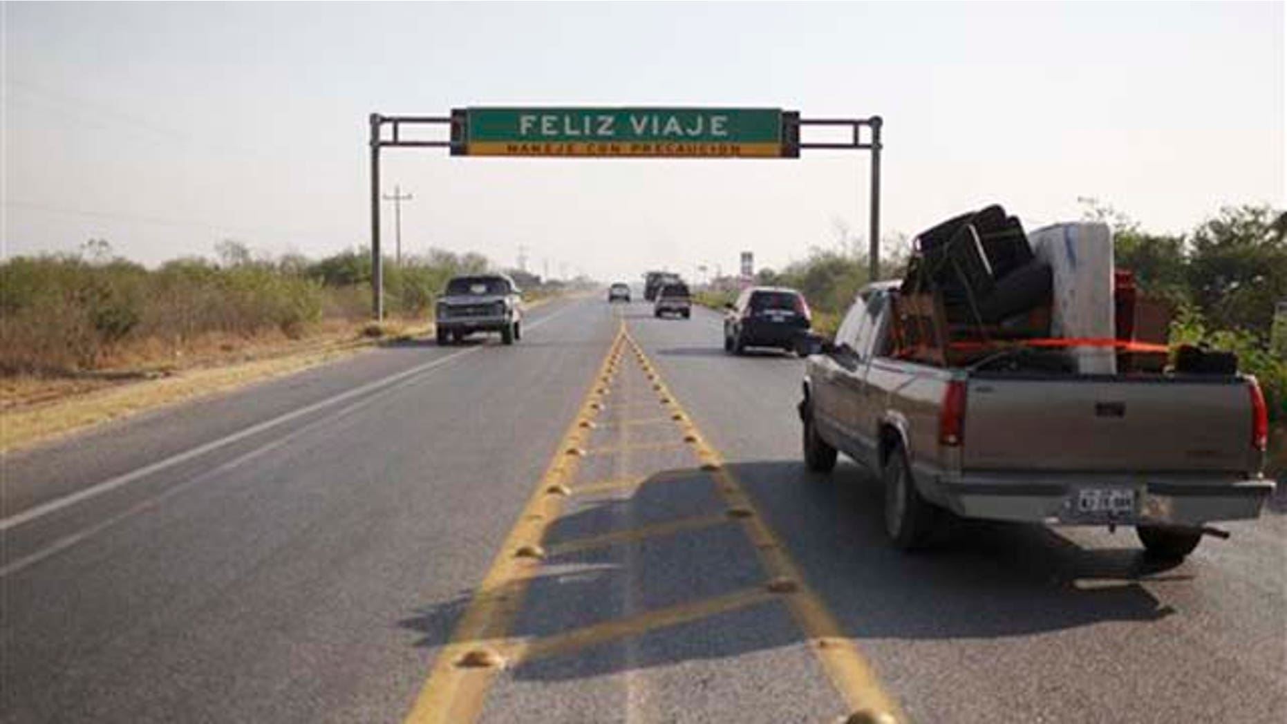 Vehicles drive past a road sign that reads in Spanish "Have a nice trip" at a highway between Ciudad Victoria and San Fernando, Tamaulipas State, Mexico, Wednesday, April 27, 2011. Security forces have unearthed six more bodies in Tamaulipas, a northeastern Mexican border state, where a drug gang is believed to be kidnapping passengers from buses and hiding their victims in secret graves, authorities said Tuesday. (AP Photo/Alexandre Meneghini)