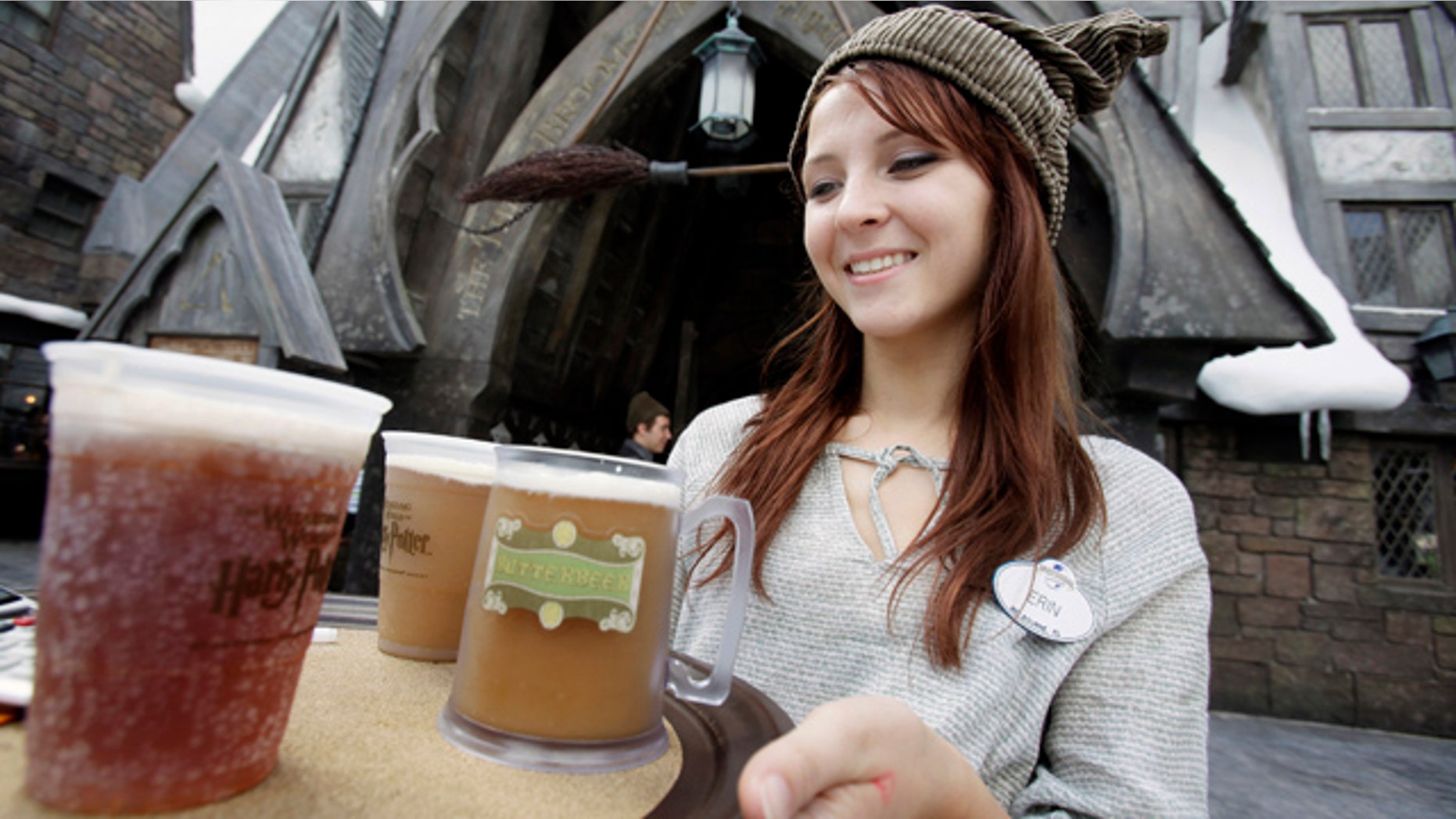 This June 9, 2010 file photo shows Erin Wuchte as she serves up Butterbeer to guests at The Wizarding World of Harry Potter at Universal Orlando theme park in Orlando, Fla. Harry has conjured all the magic Universal expected, and then some. In the quarter after the attraction opened, crowds at Universal parks swelled by 36 percent over the same stretch last year, while attendance at Disney's Orlando parks stayed roughly the same. (AP Photo/John Raoux, FILE)