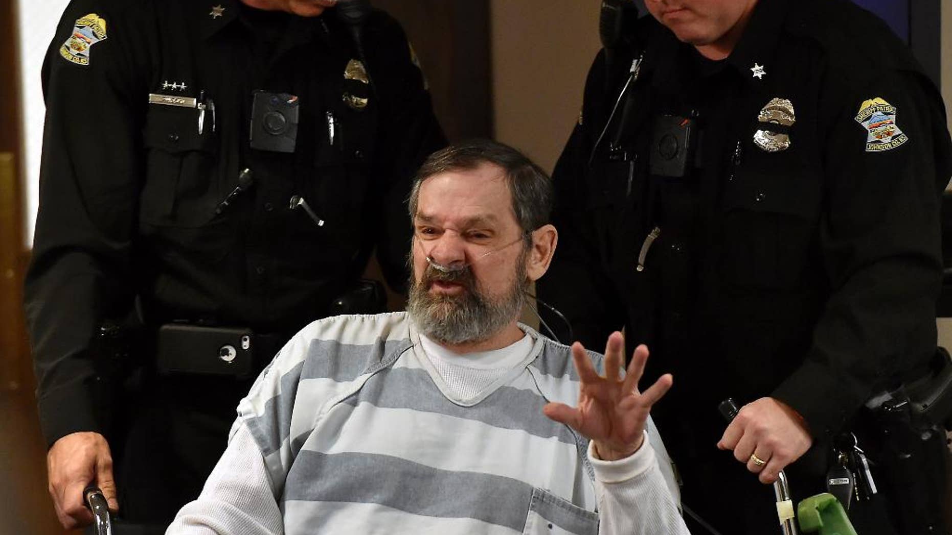 FILE - In this April 2014 file photo, Frazier Glenn Miller is wheeled out of a Johnson County, Kan., courtroom. A judge ruled Tuesday, March 2, 2015 that Miller, 74, will go on trial for the 2014 deaths of Dr. William Lewis Corporon, 69, and his grandson, Reat Griffin Underwood, 14, at the Jewish Community Center of Greater Kansas City in Overland Park and Terri LaManno, 53, at a nearby Jewish retirement home. (AP Photo/The Kansas City Star, Rich Sugg, Pool, File)