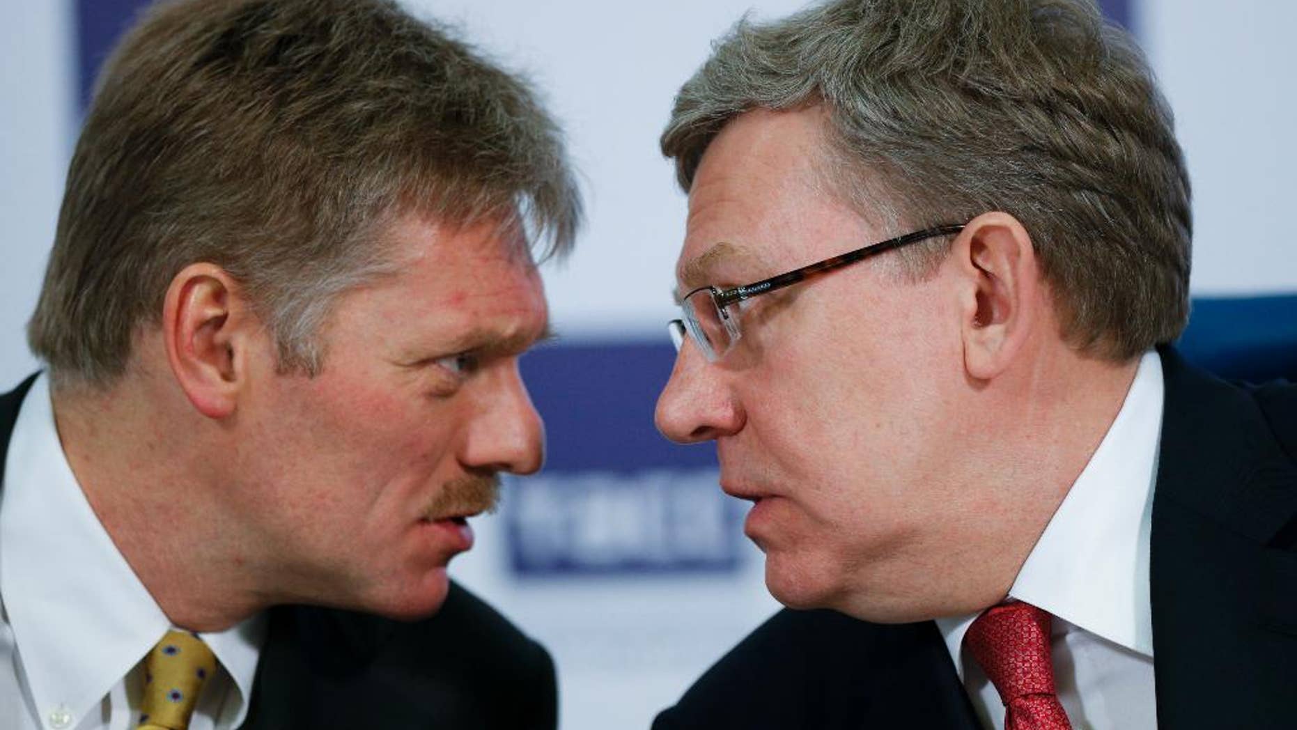 Russian President Vladimir Putin's press secretary Dmitry Peskov, left, speaks to Russia's former finance minister Alexei Kudrin at a round table to mark President Vladimir Putin’s 15 years in office, some of the president’s long-term allies questioned his political course and warned of economic fallout in Moscow, Russia, Tuesday, March 31, 2015. Alexei Kudrin, Russia's finance minister in 2000-2011 and a former deputy prime minister, said Tuesday that Putin's focus on foreign policy means that Russia won't return in the coming years to the economic growth that would suit a great power. (AP Photo/Alexander Zemlianichenko)