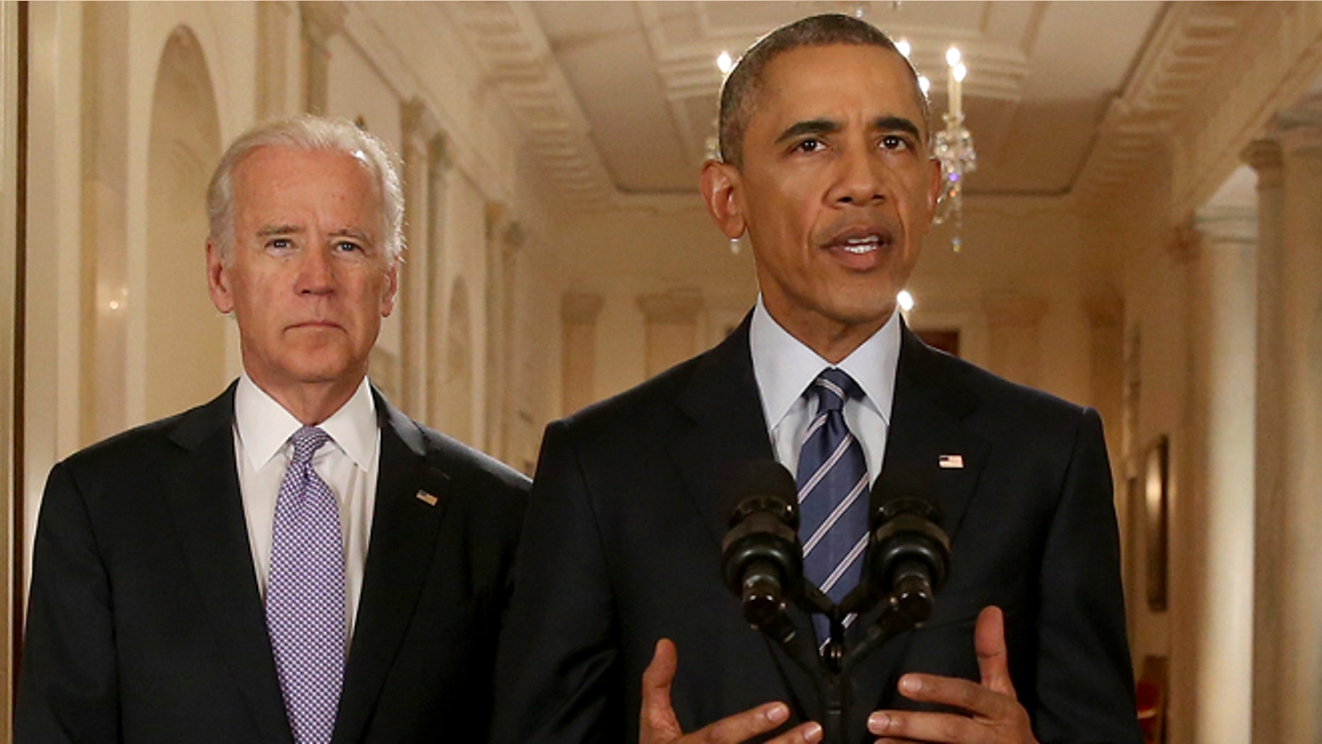 President Obama, standing with Vice President Biden, delivers remarks in the White House on July 14, 2015.