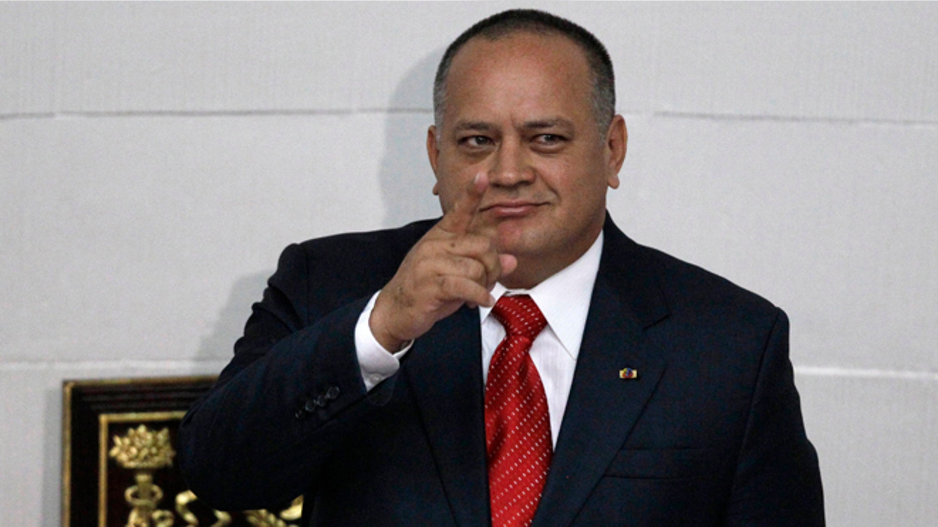 FILE - In this Jan. 5, 2013, file photo, National Assembly President Diosdado Cabello gestures before addressing the National Assembly in Caracas, Venezuela. Cabello said Tuesday, April 22, 2015, that he will file a lawsuit against the outlets that published reports in January saying his bodyguard had defected to the United States to testify that his former boss heads a drug ring of political and military officials. (AP Photo/Ariana Cubillos, File)