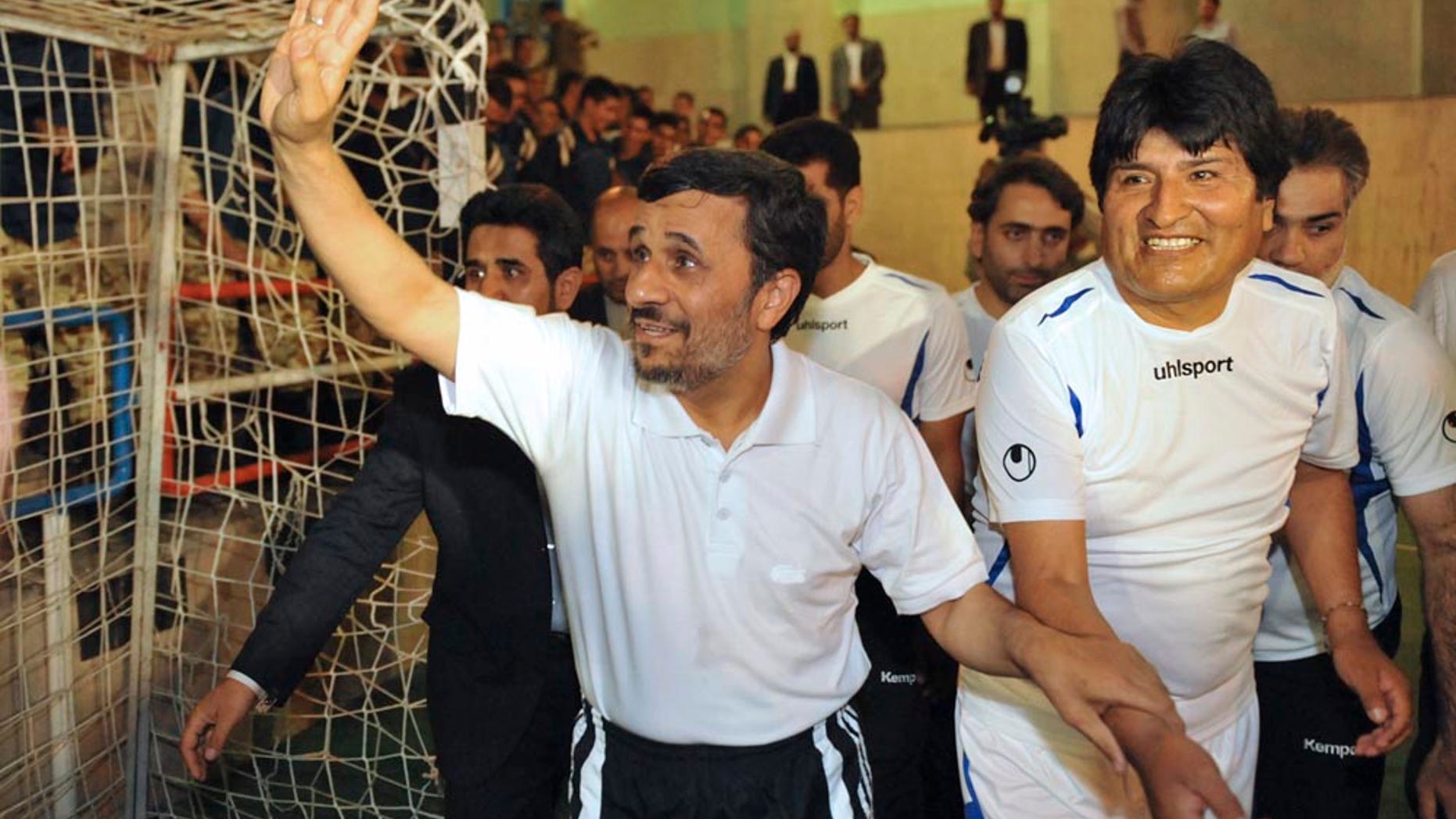 In this picture taken on Tuesday, Oct. 26, 2010, Iranian President Mahmoud Ahmadinejad, left, holds the hand of his Bolivian counterpart, Evo Morales, prior to a friendly Fursal, in Tehran, Iran. (AP Photo/ISNA, Amir Kholousi)
