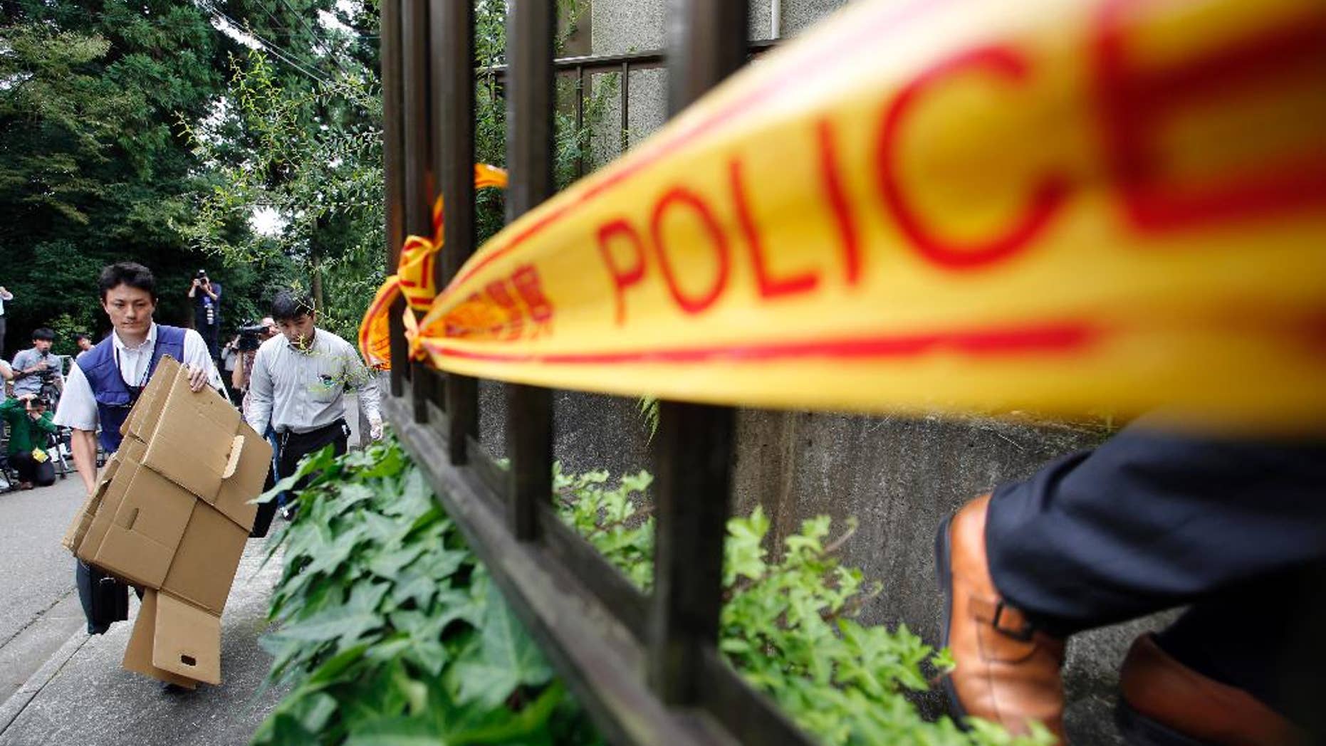 Police enter the home of suspect Satoshi Uematsu.